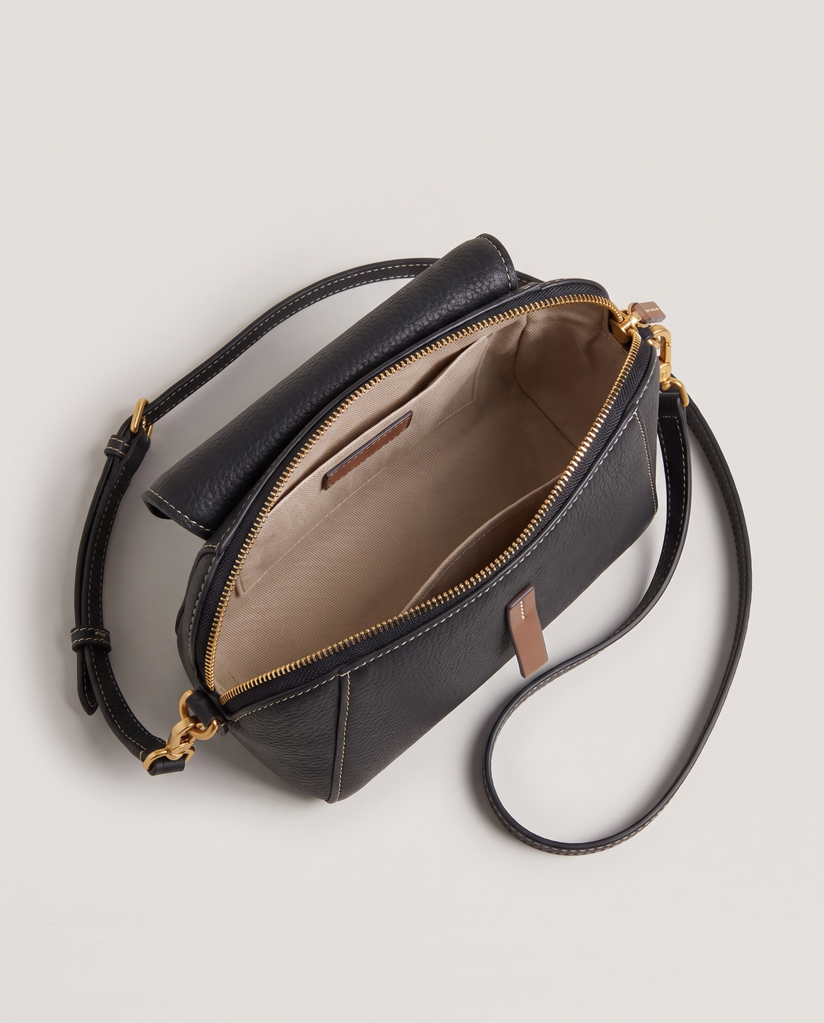 Elara mini leather crossbody in Black – open, showing the lined interior