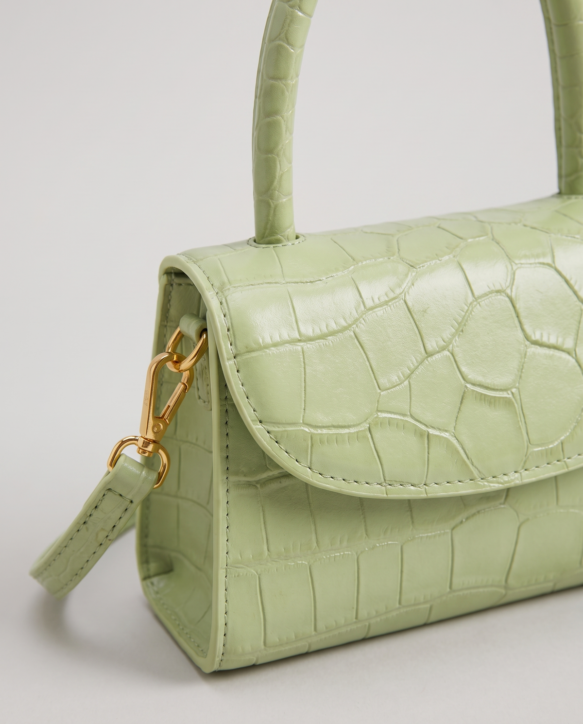 Fern mini croc top-handle bag in Pistachio – close-up of the croc texture and flap