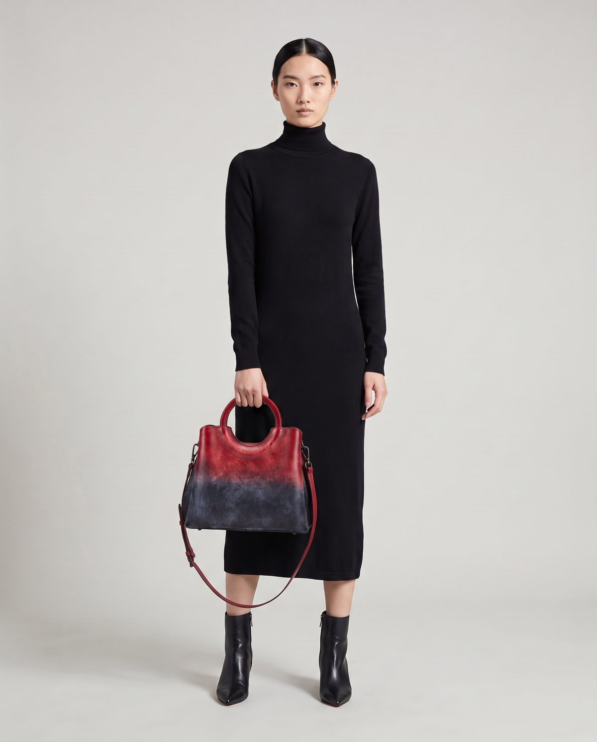 Ombra hand-painted ombré leather bag in Red – model holding it by the ring handles, full length