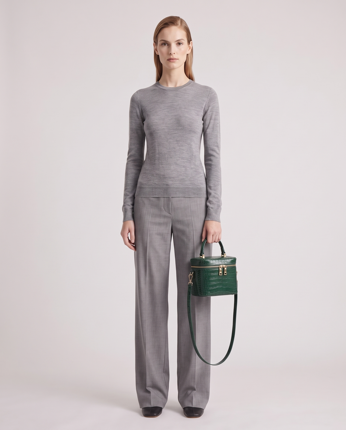 Brindisi croc-embossed vanity bag in Emerald – model holding it, full length