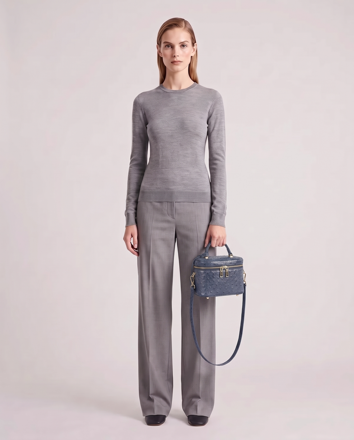 Brindisi ostrich-embossed vanity bag in Slate Blue – model holding it, full length