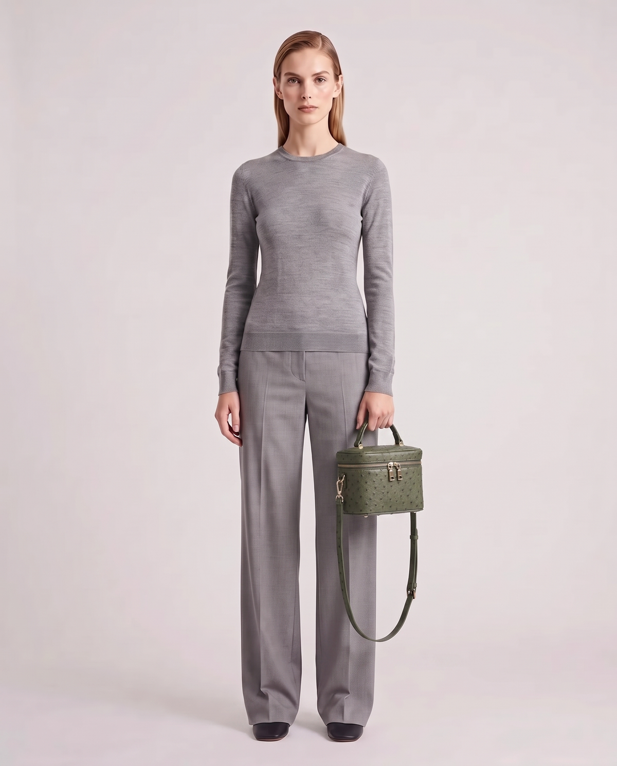 Brindisi ostrich-embossed vanity bag in Olive – model holding it, full length