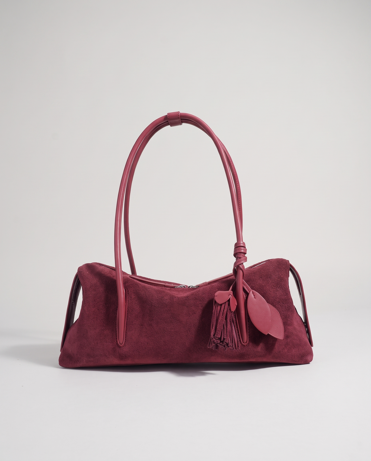 Isola suede shoulder bag in burgundy, front view