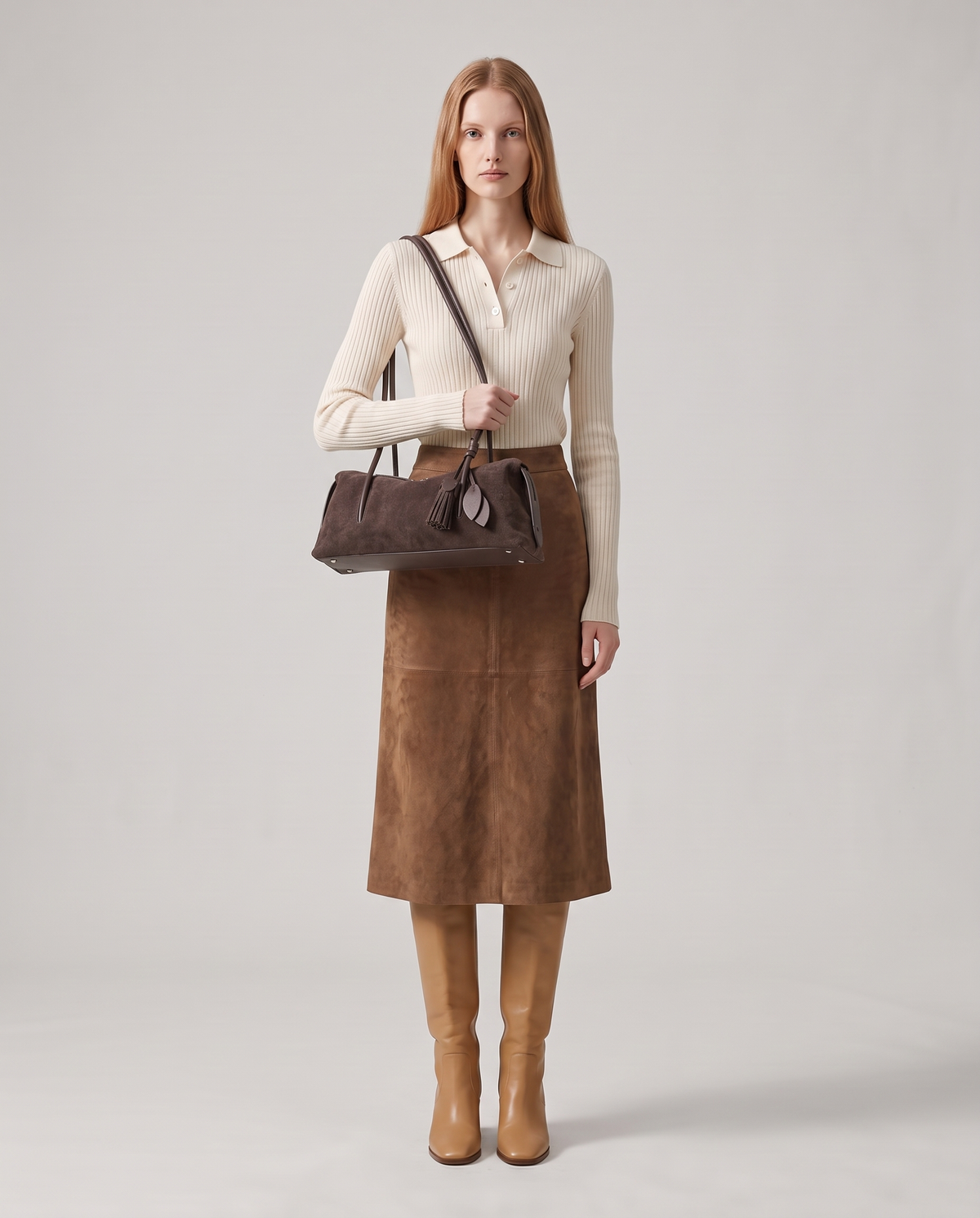 Model carrying the Isola suede shoulder bag in mocha, full length