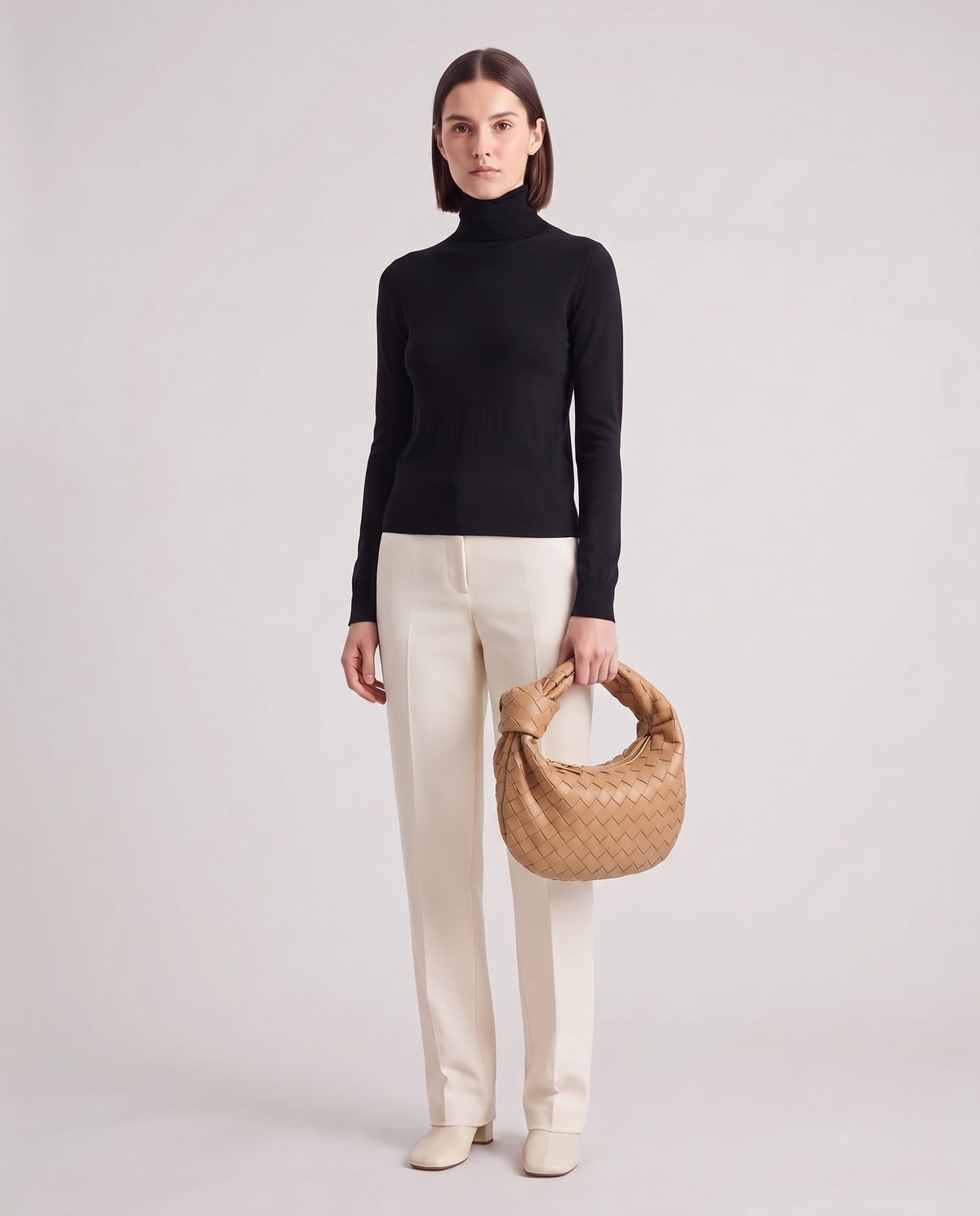 Knot Midi woven leather bag in Caramel – model holding it, full length