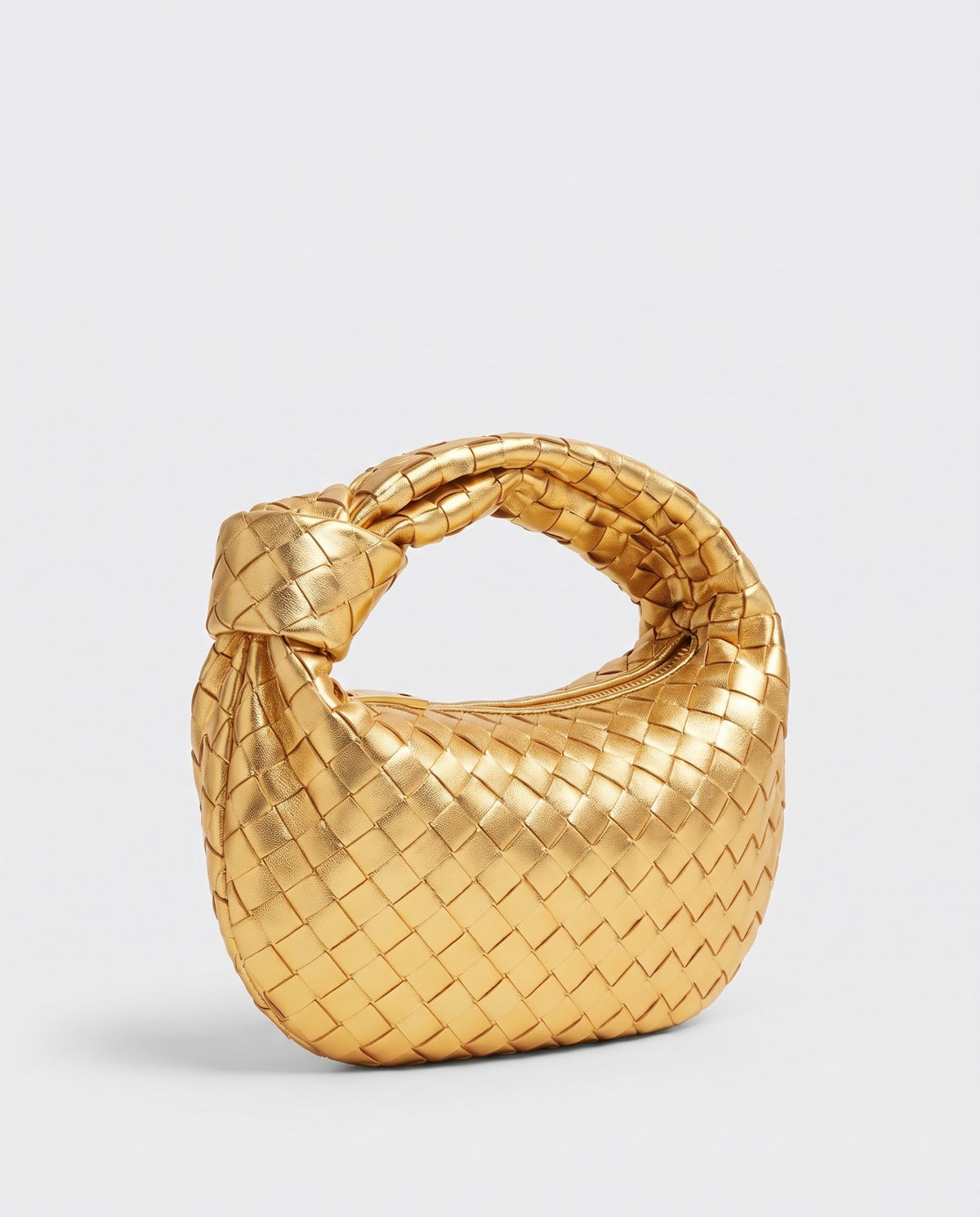 Knot Mini woven leather bag in Gold – three-quarter view