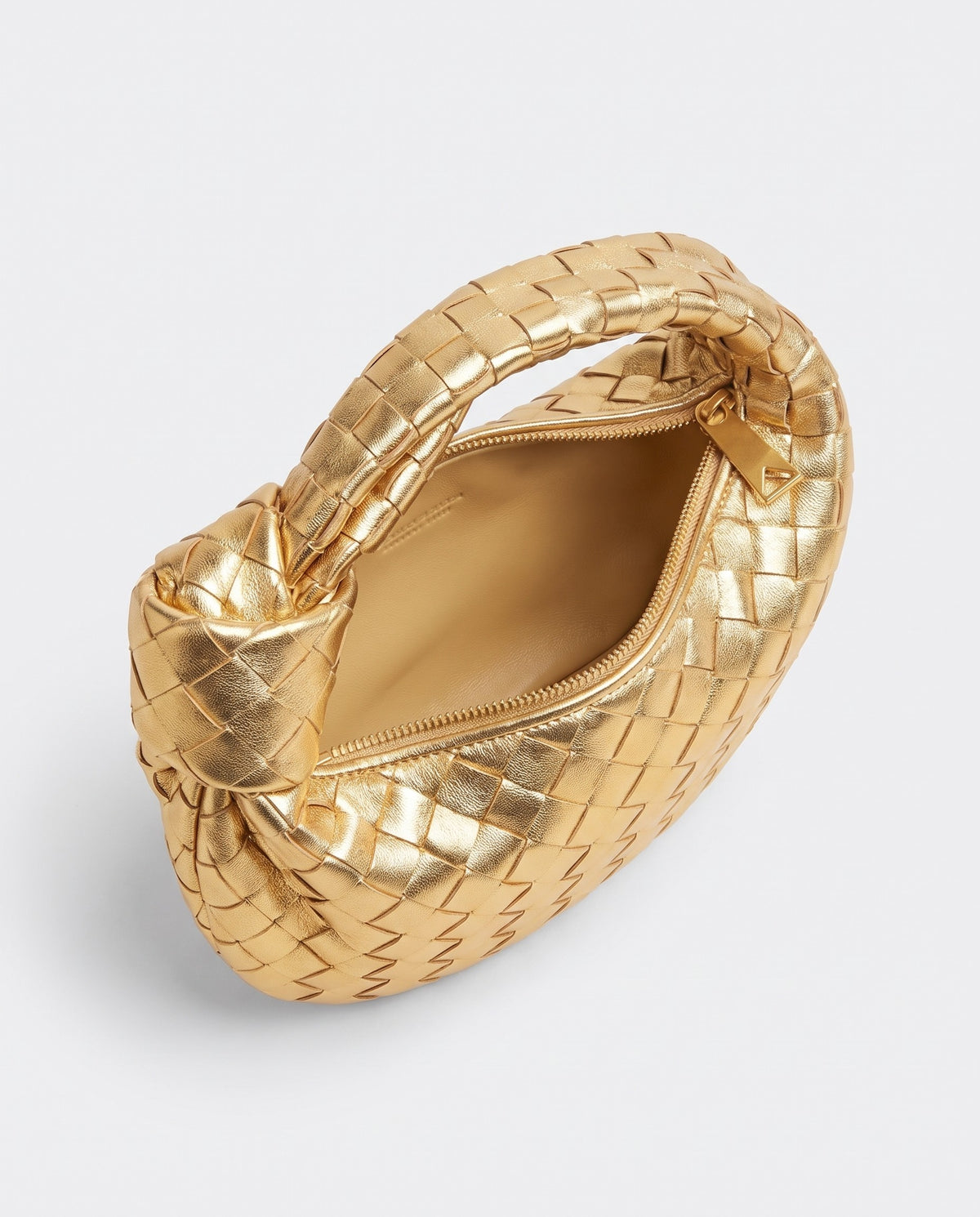 Knot Mini woven leather bag in Gold – inside view with the zip open
