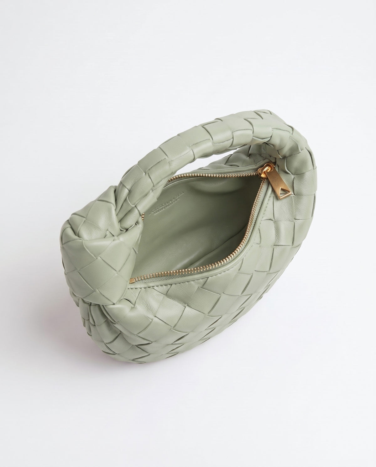 Knot Mini woven leather bag in Pistachio – inside view with the zip open