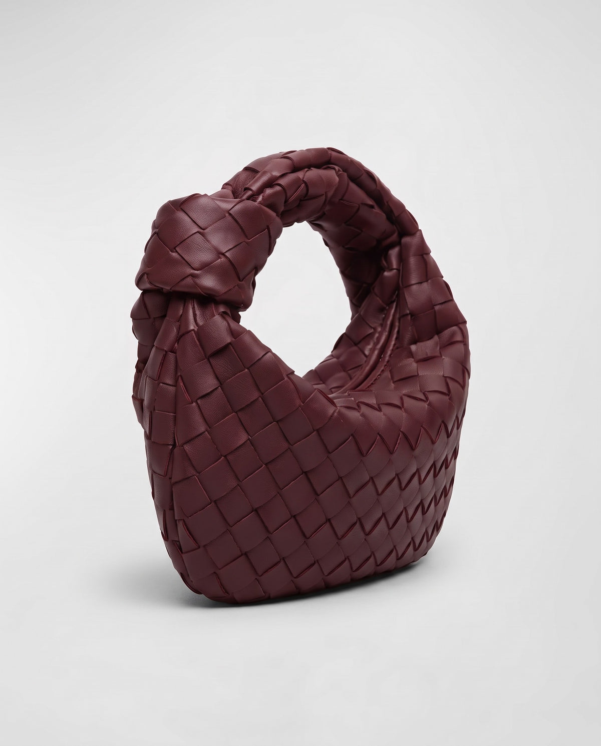 Knot Small woven leather bag in Bordeaux – three-quarter view