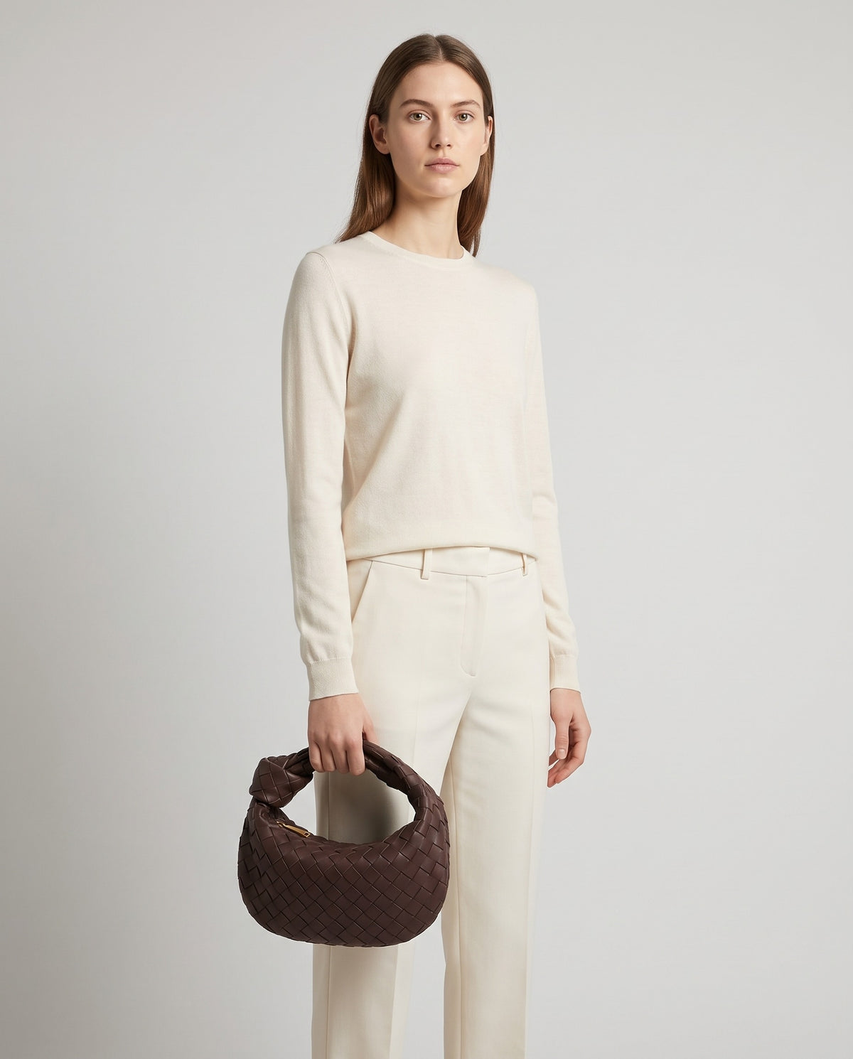 Knot Small woven leather bag in Espresso – model holding it, full length