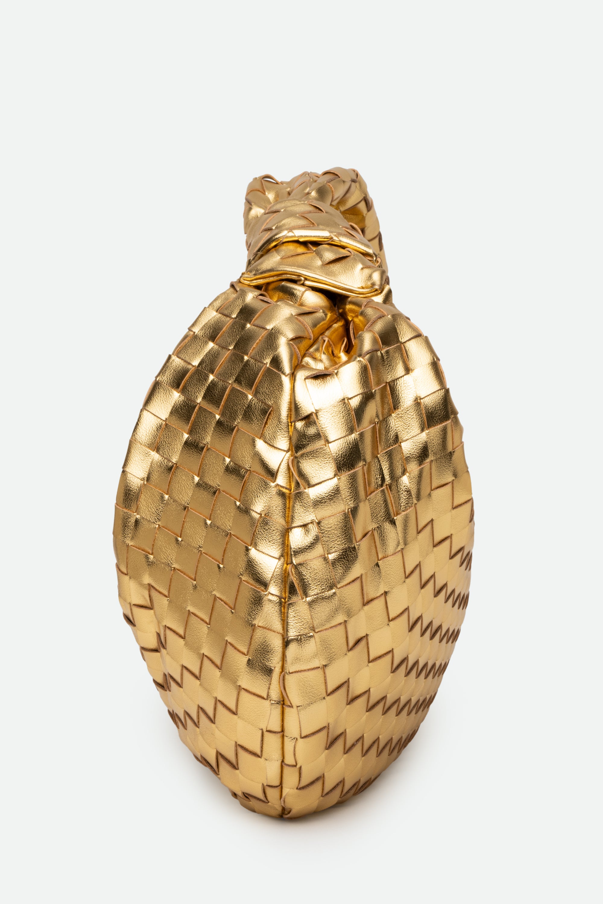Side view of Large Knot Bag (Jodie) gold woven handbag standing upright.