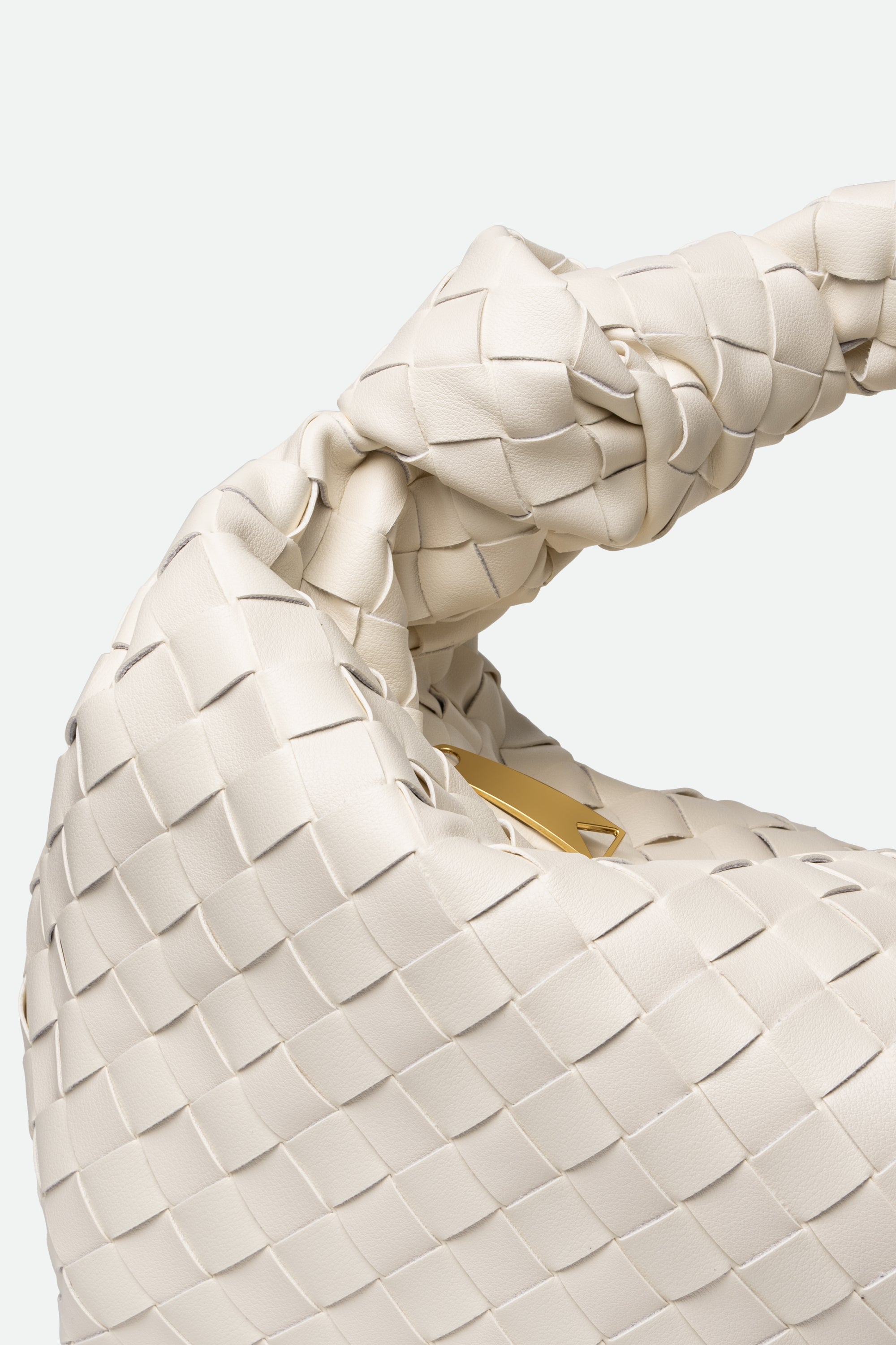 Close-up of Large Knot Bag (Jodie) with woven beige texture and visible brand logo