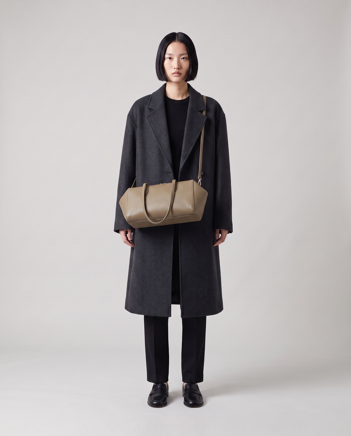 Lira leather shoulder bag in Khaki – model wearing it on her shoulder, full length