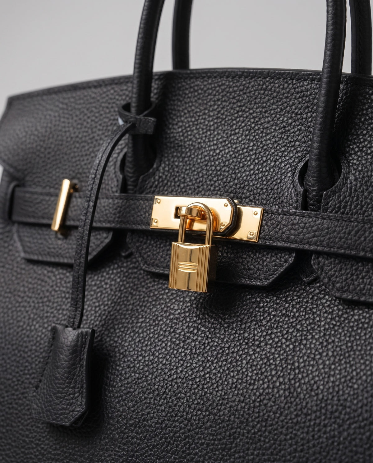 Lock Large leather top-handle bag in Black – close-up of the gold turn-lock and padlock