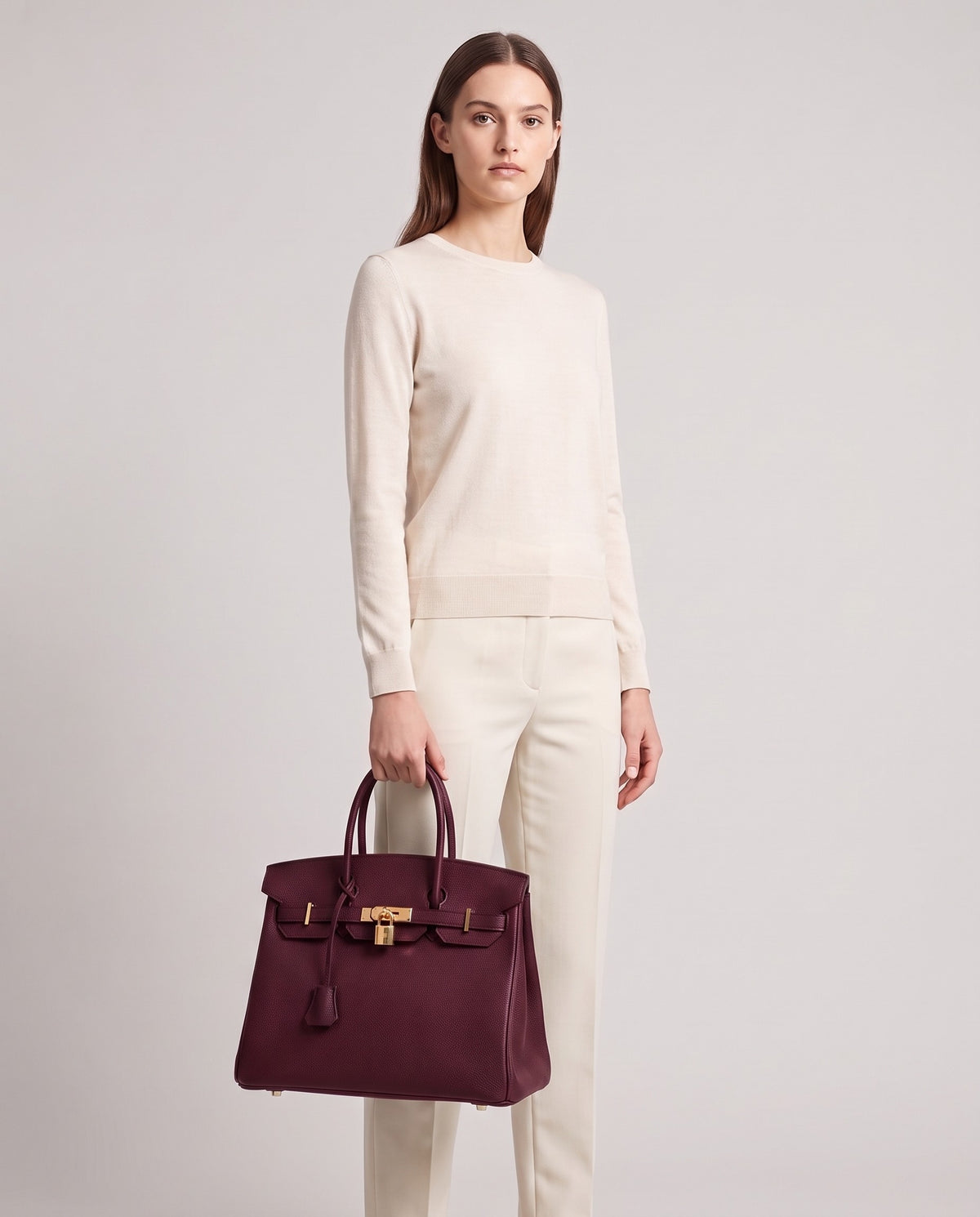 Lock Large leather top-handle bag in Bordeaux – model holding it, full length