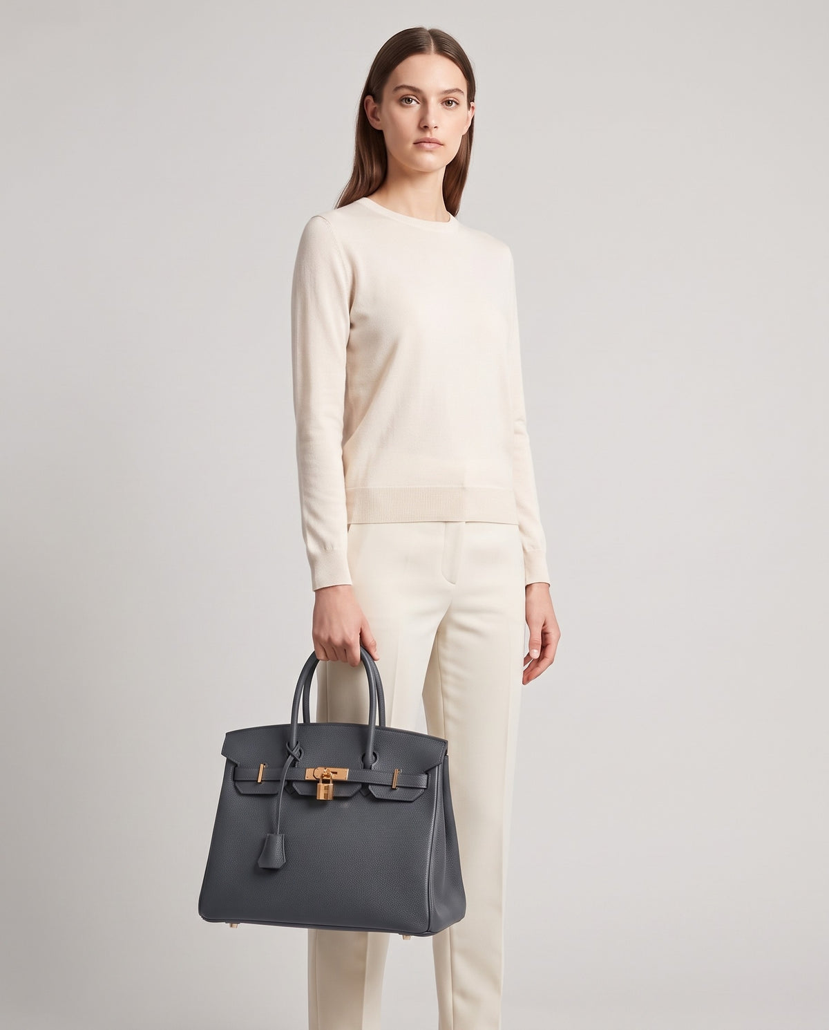 Lock Large leather top-handle bag in Charcoal – model holding it, full length