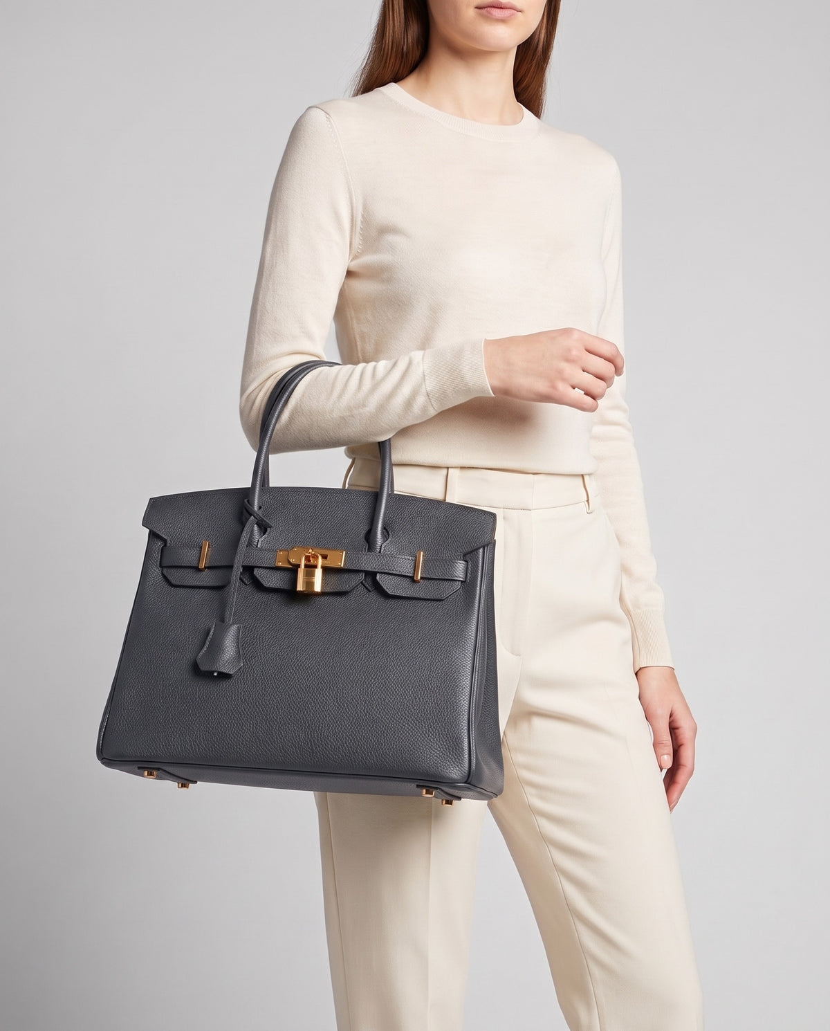 Lock Medium leather top-handle bag in Charcoal – model carrying it