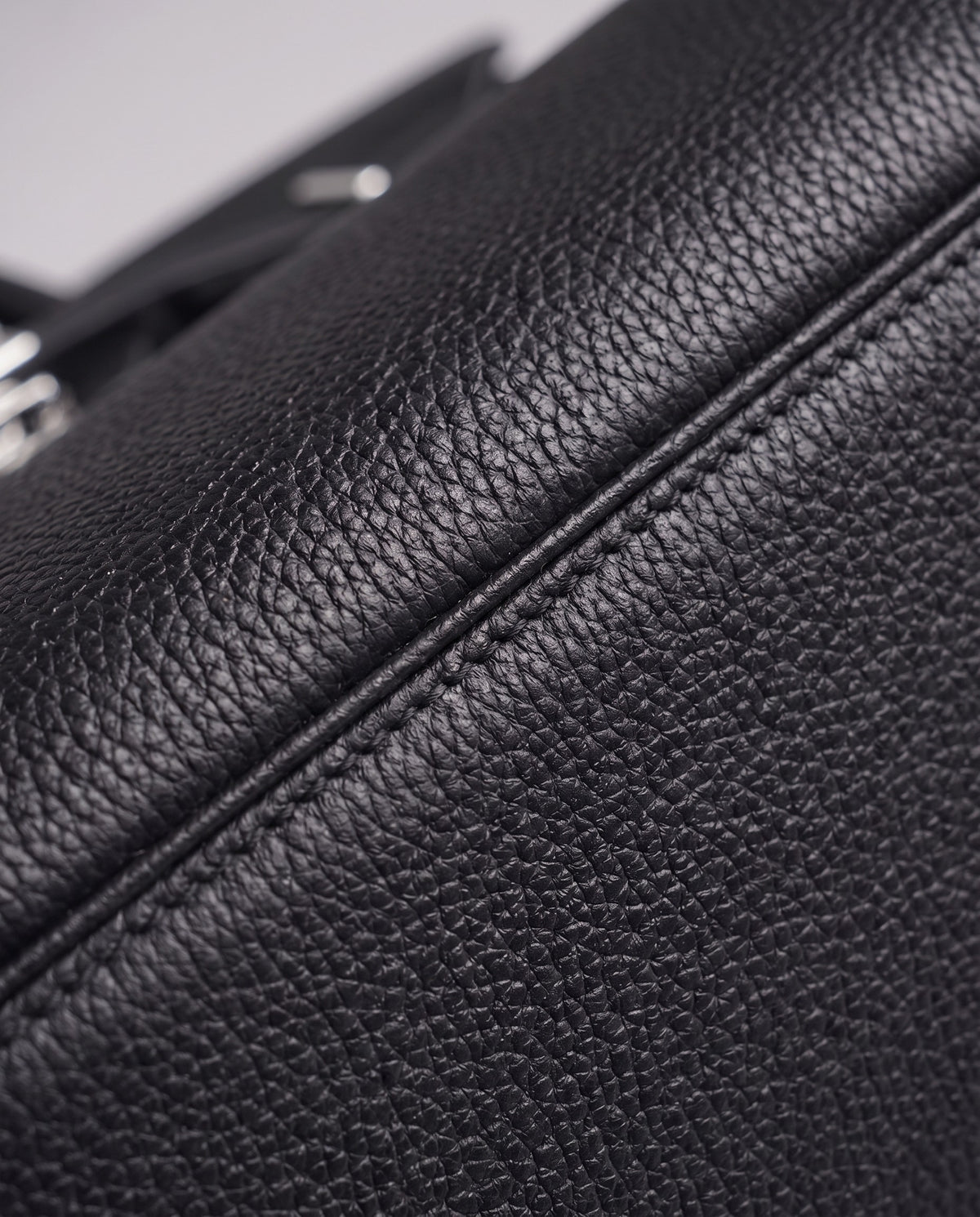 Lock Medium leather top-handle bag in Onyx – close-up of the pebbled leather and stitching
