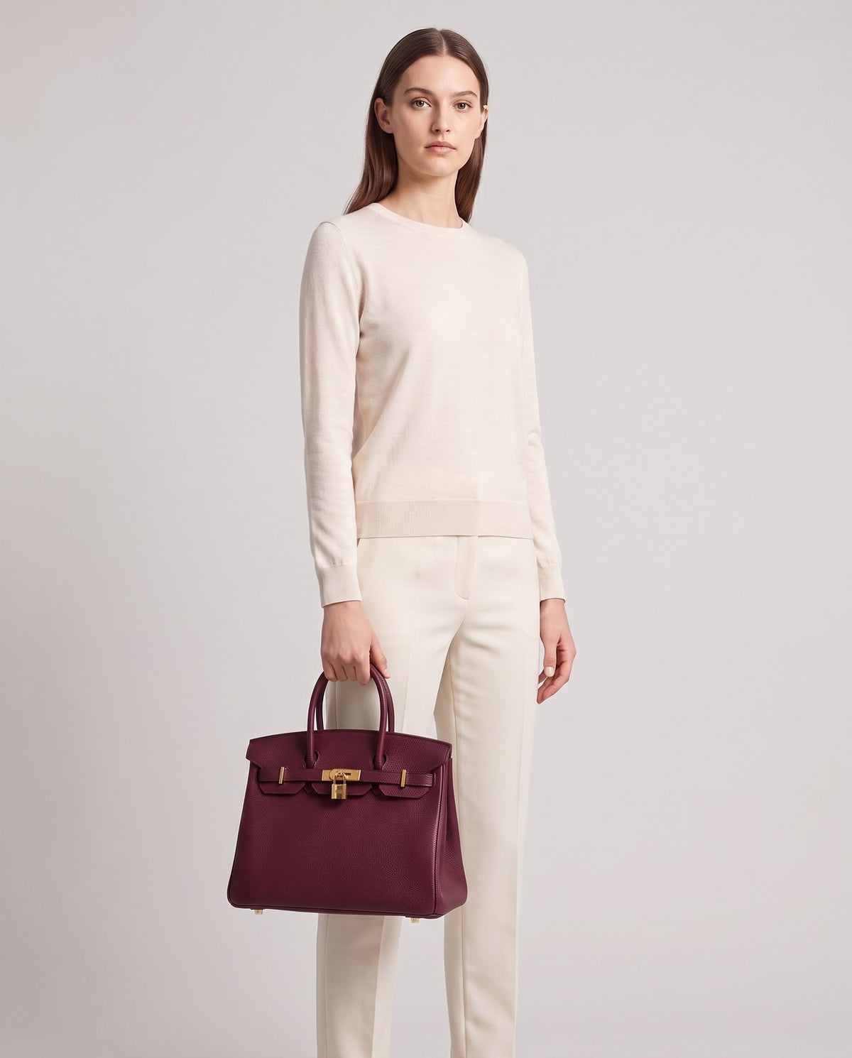 Lock Small leather top-handle bag in Bordeaux – model holding it, full length