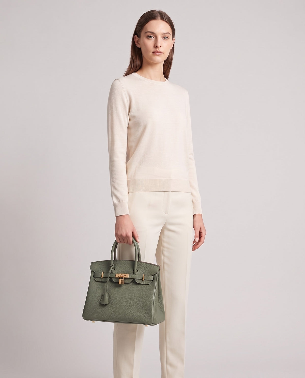 Lock Small leather top-handle bag in Celadon – model holding it, full length