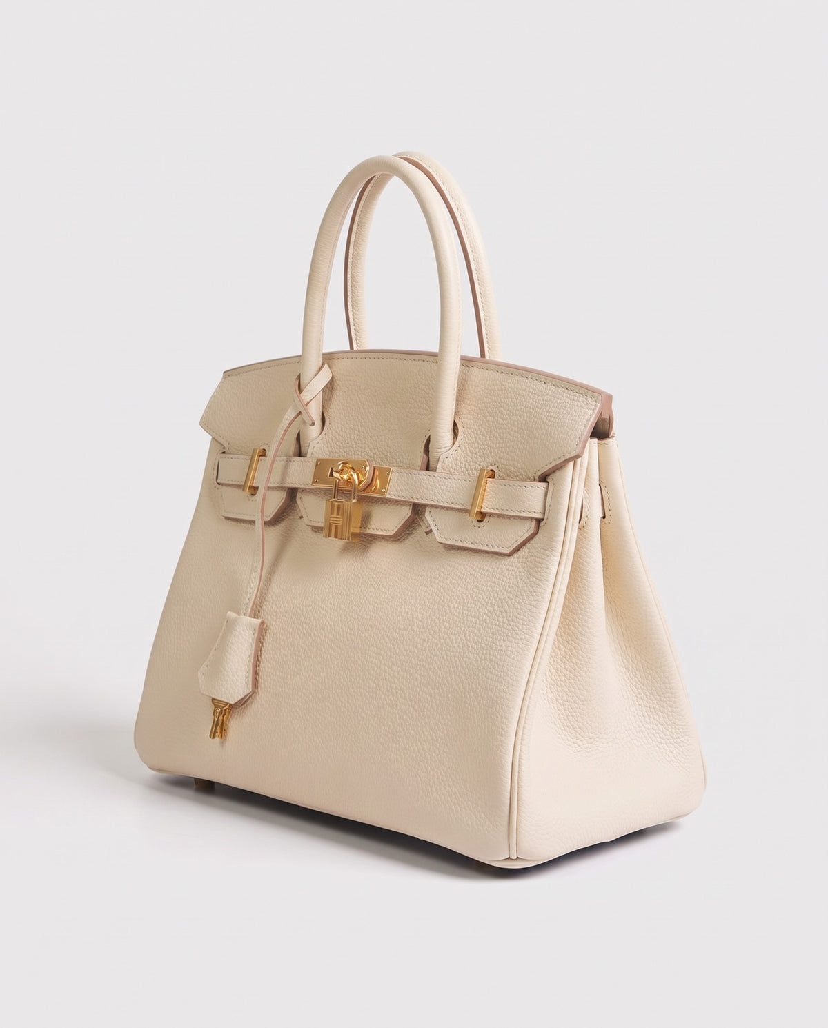 Lock Small leather top-handle bag in Cream – three-quarter view