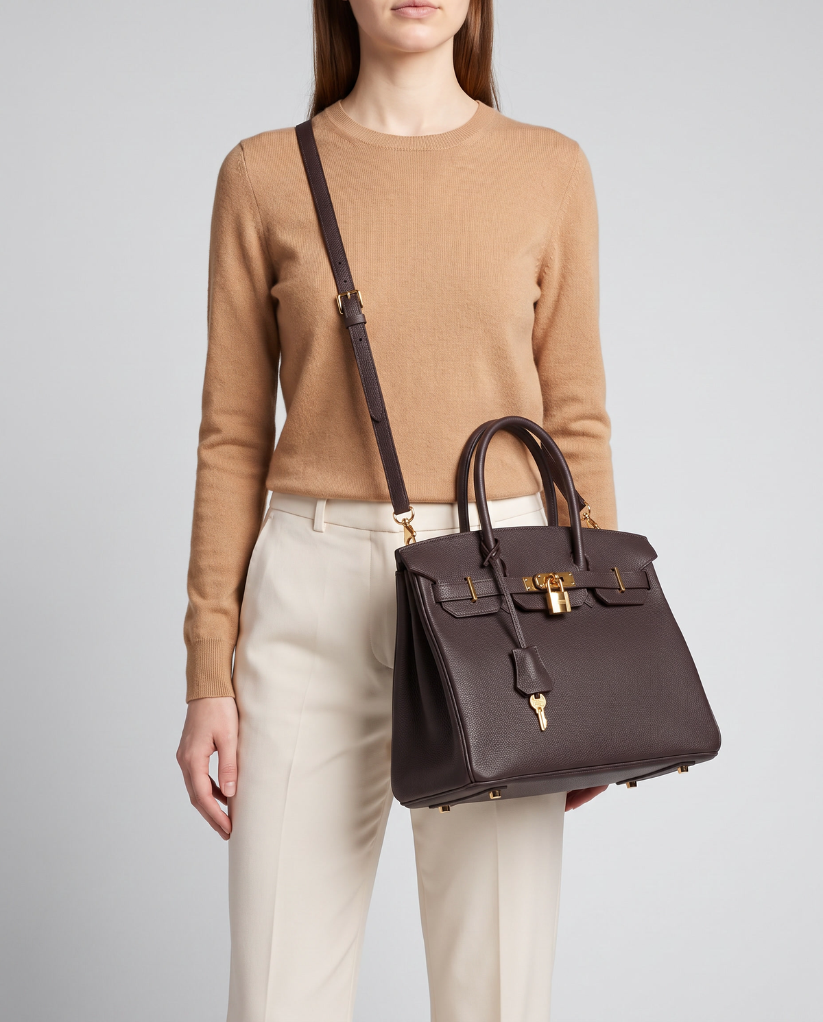 Lock Small leather top-handle bag in Espresso – model wearing it crossbody on the detachable shoulder strap