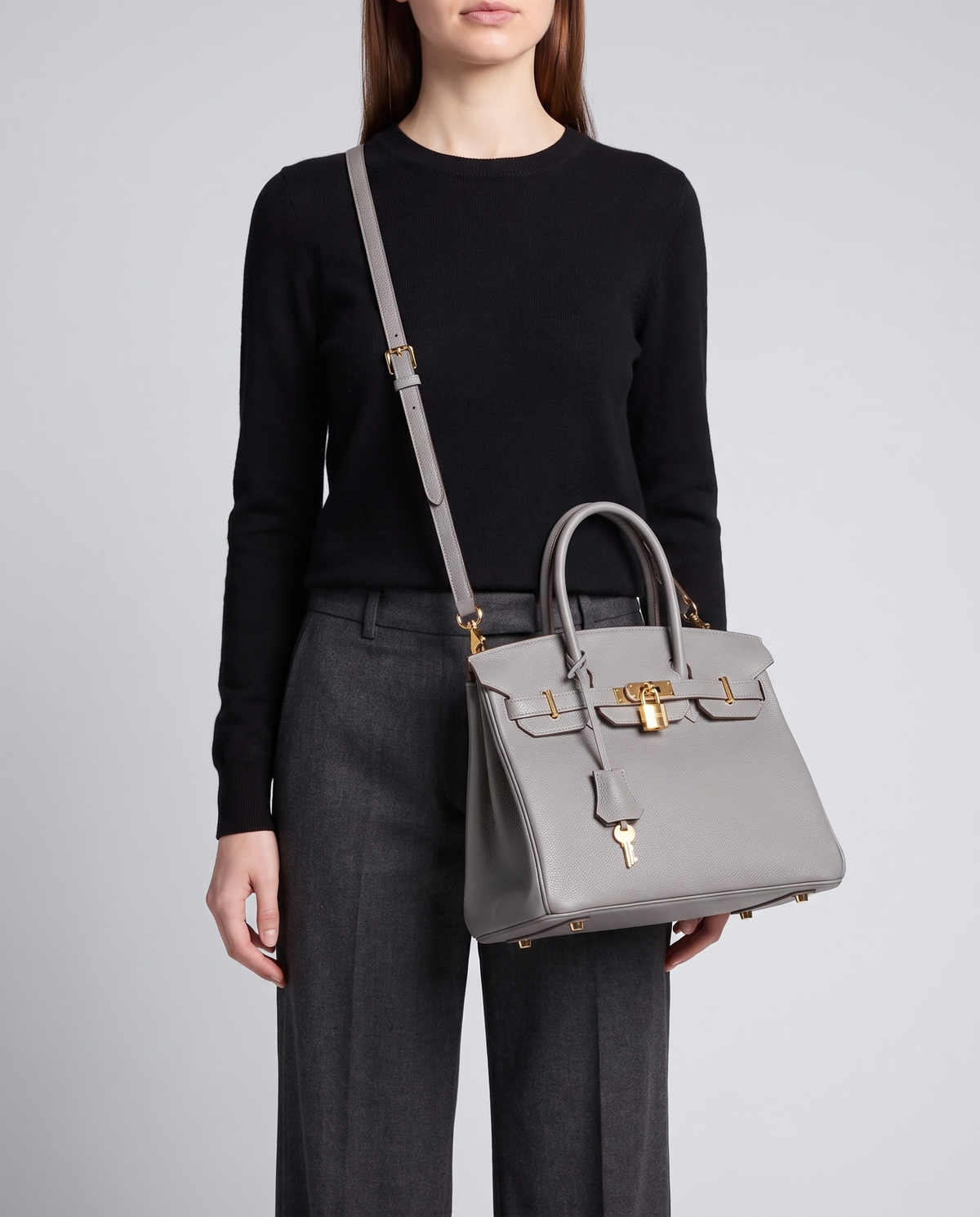 Lock Small leather top-handle bag in Grey – model wearing it crossbody on the detachable shoulder strap