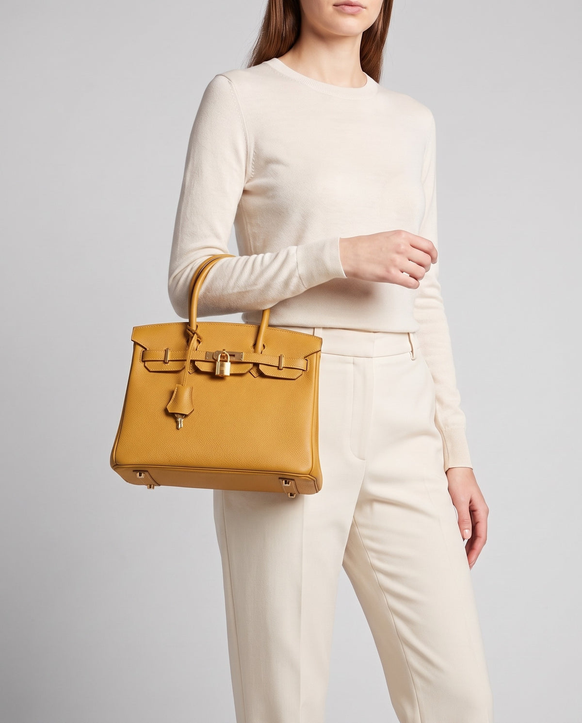 Lock Small leather top-handle bag in Mustard – model carrying it