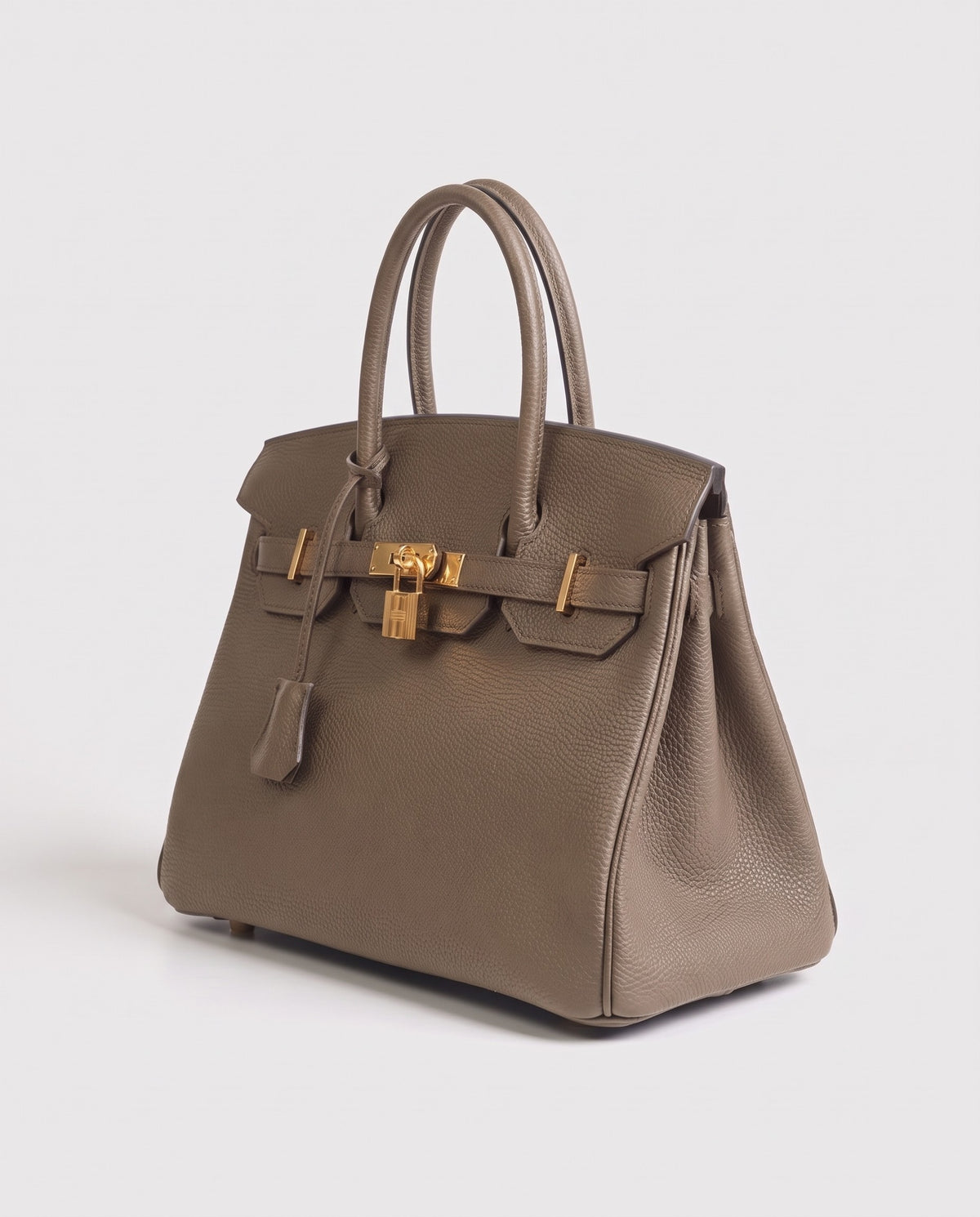 Lock Small leather top-handle bag in Taupe – three-quarter view