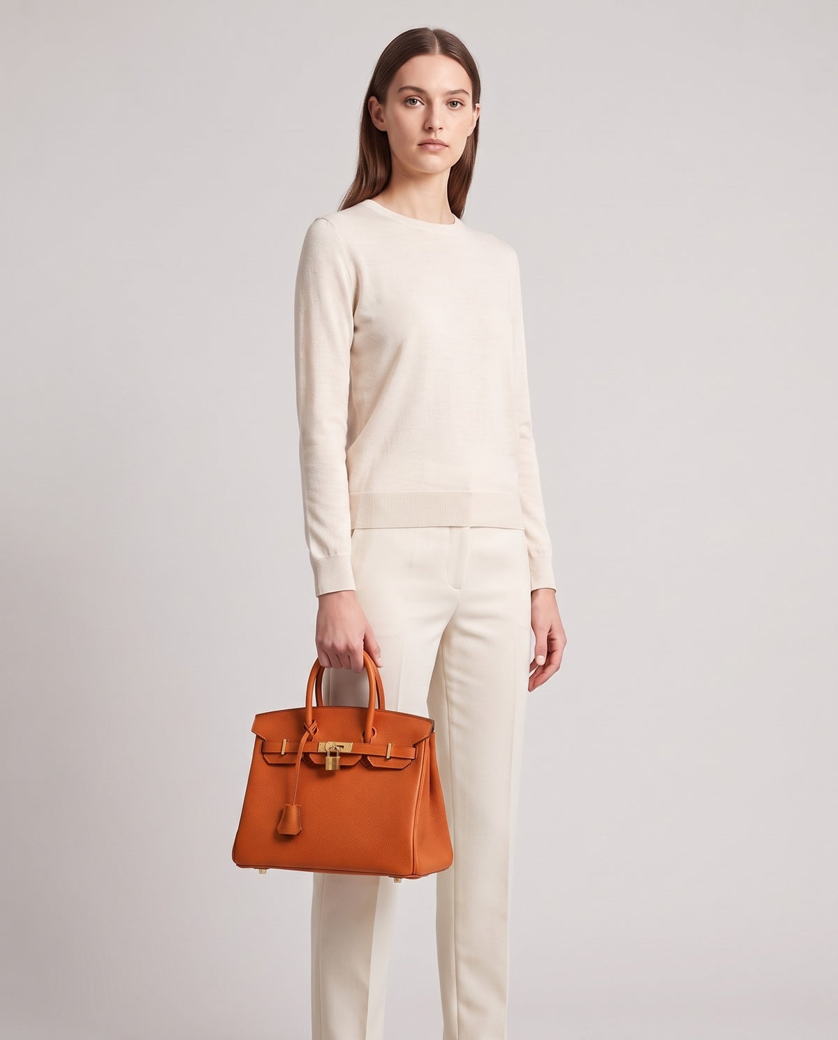 Lock Small leather top-handle bag in Terracotta – model holding it, full length
