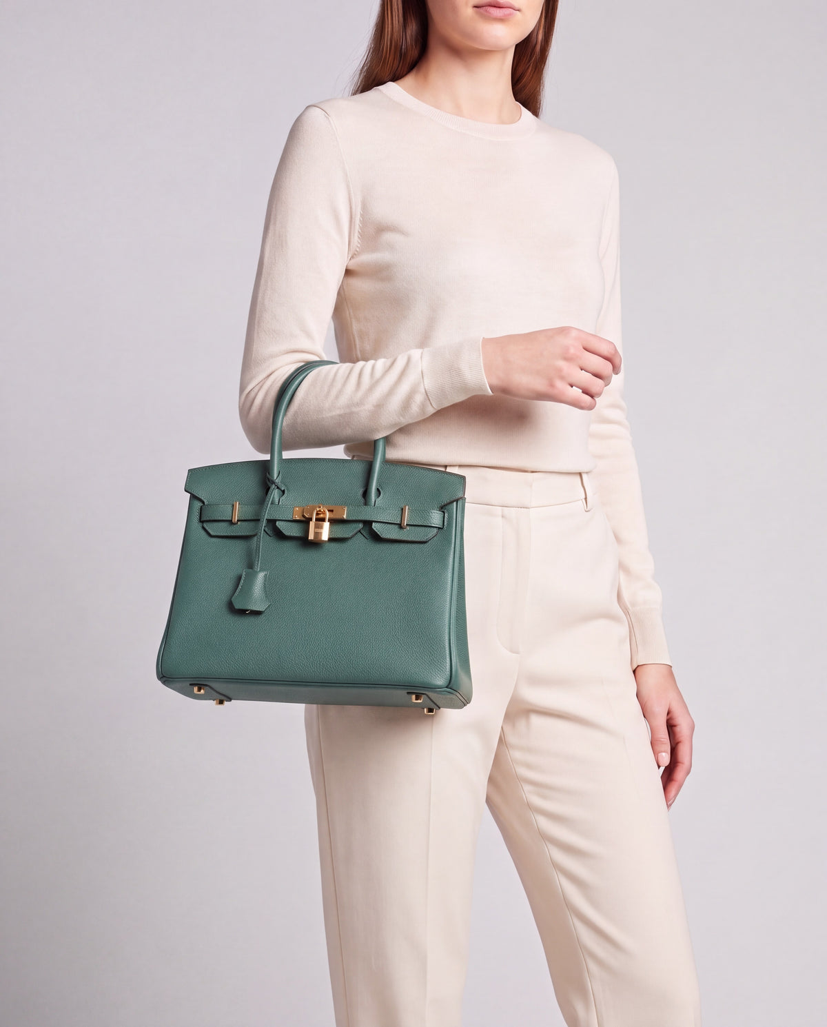 Lock Small leather top-handle bag in Velvet Green – model carrying it