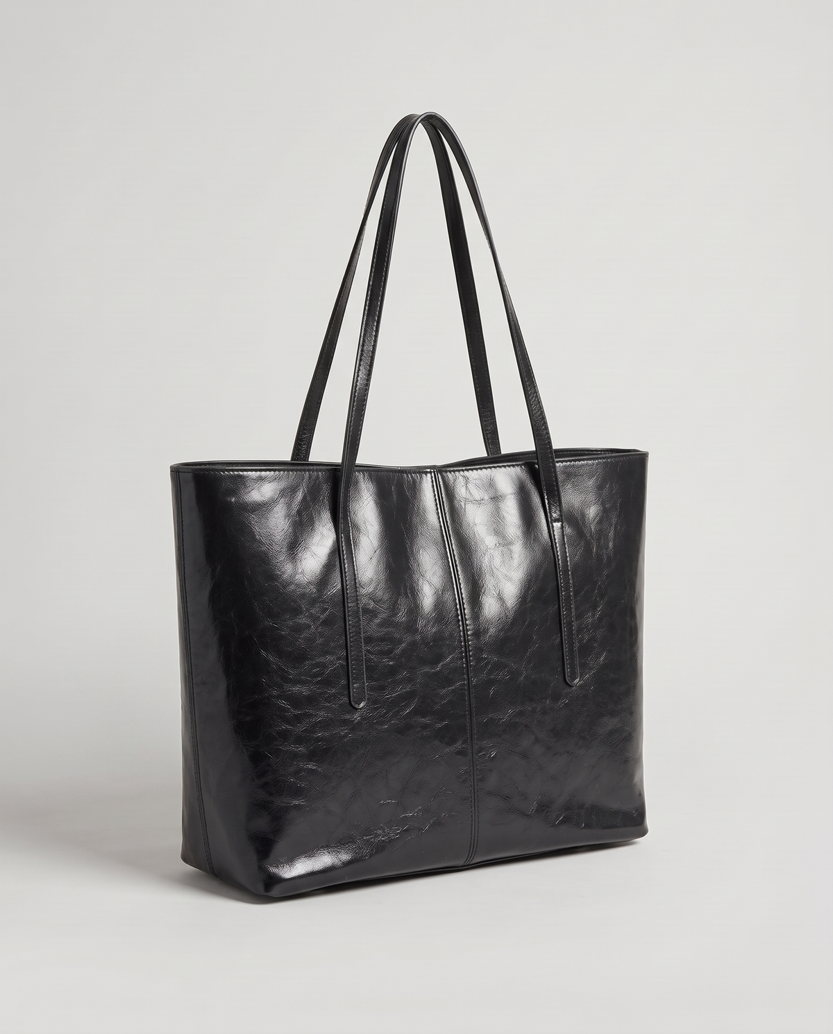 Molo oil-waxed leather tote in black, three-quarter view