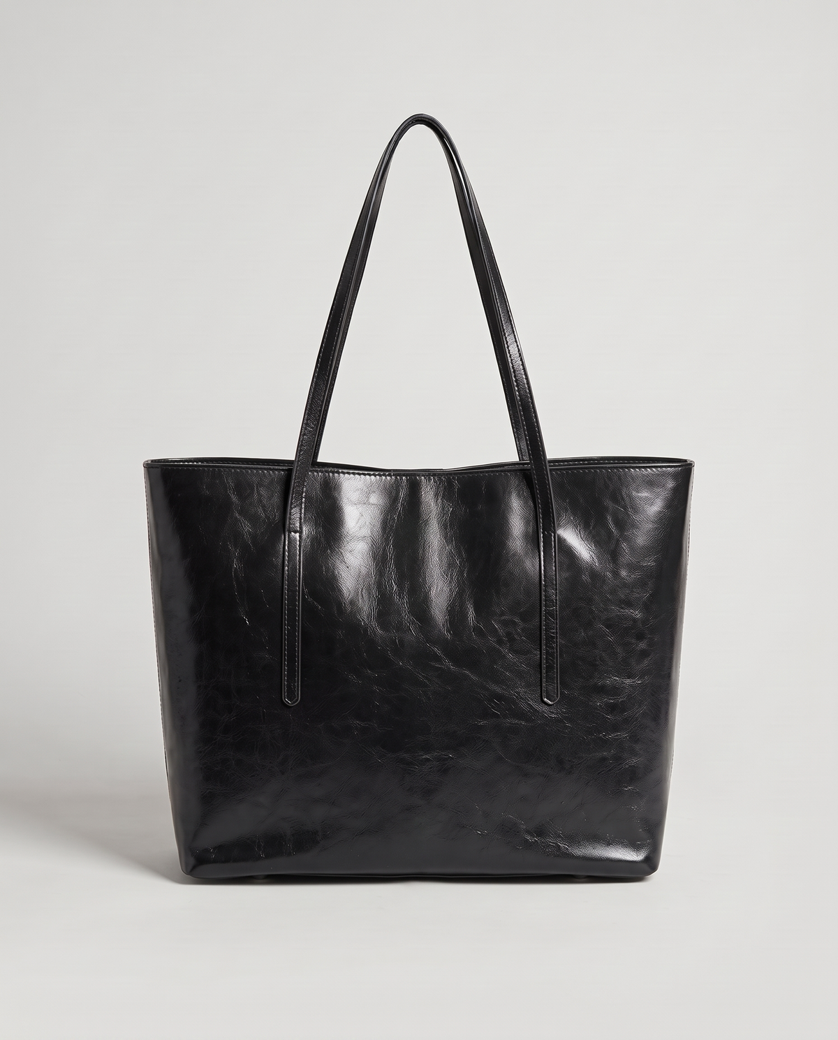 Molo oil-waxed leather tote in black, back view
