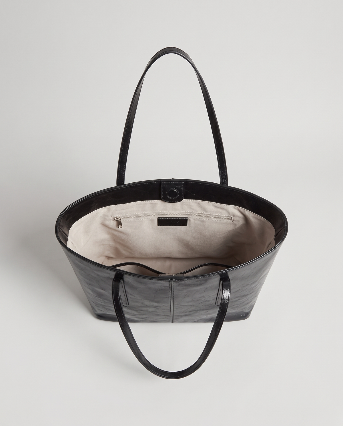 Molo oil-waxed leather tote in black, open showing interior