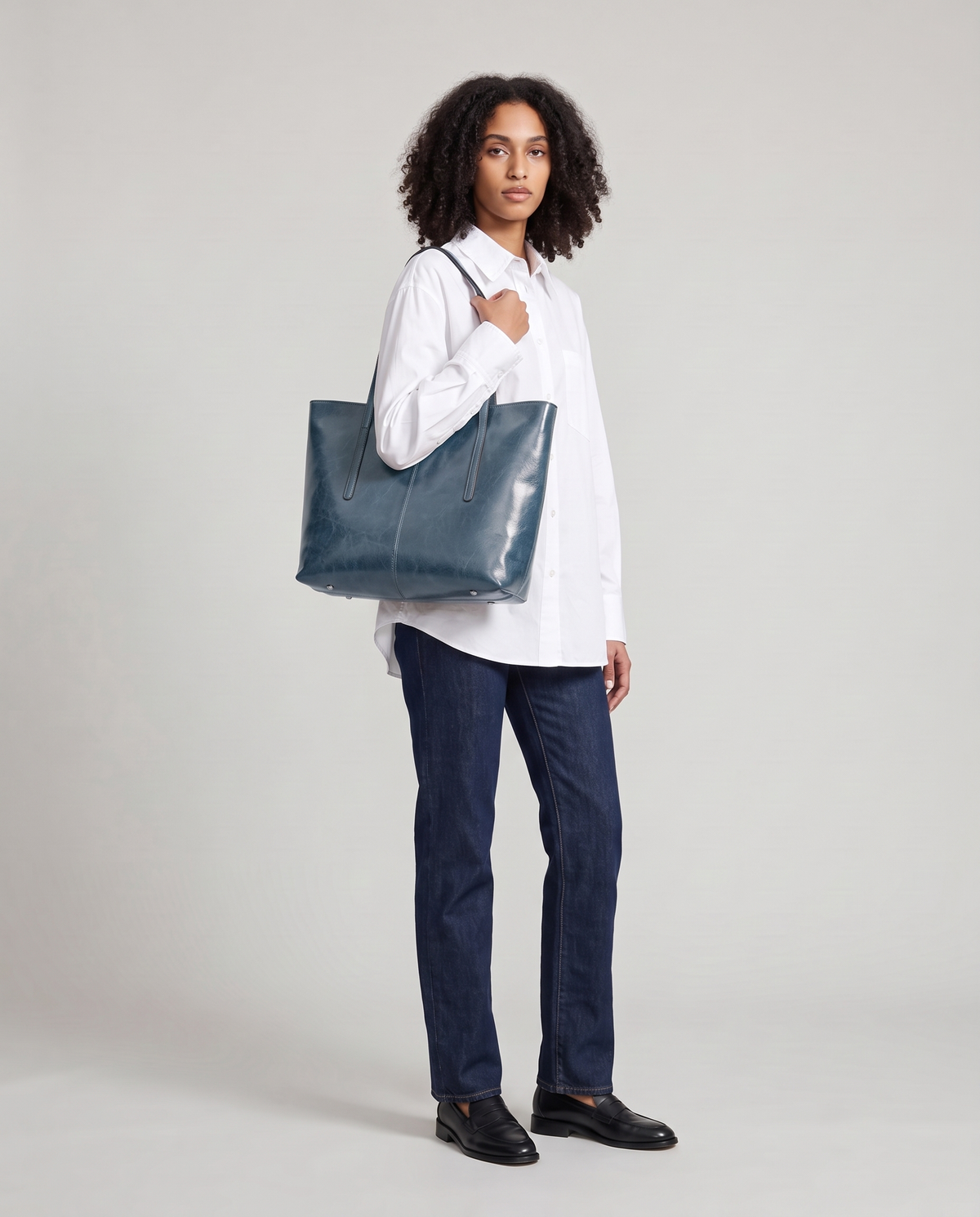 Model with the Molo oil-waxed leather tote in denim, full length