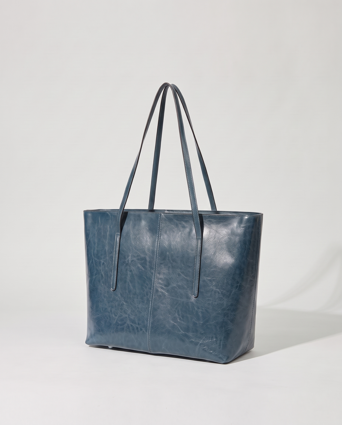 Molo oil-waxed leather tote in denim, three-quarter view