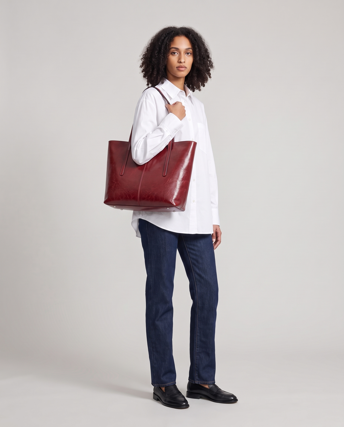Model with the Molo oil-waxed leather tote in red, full length
