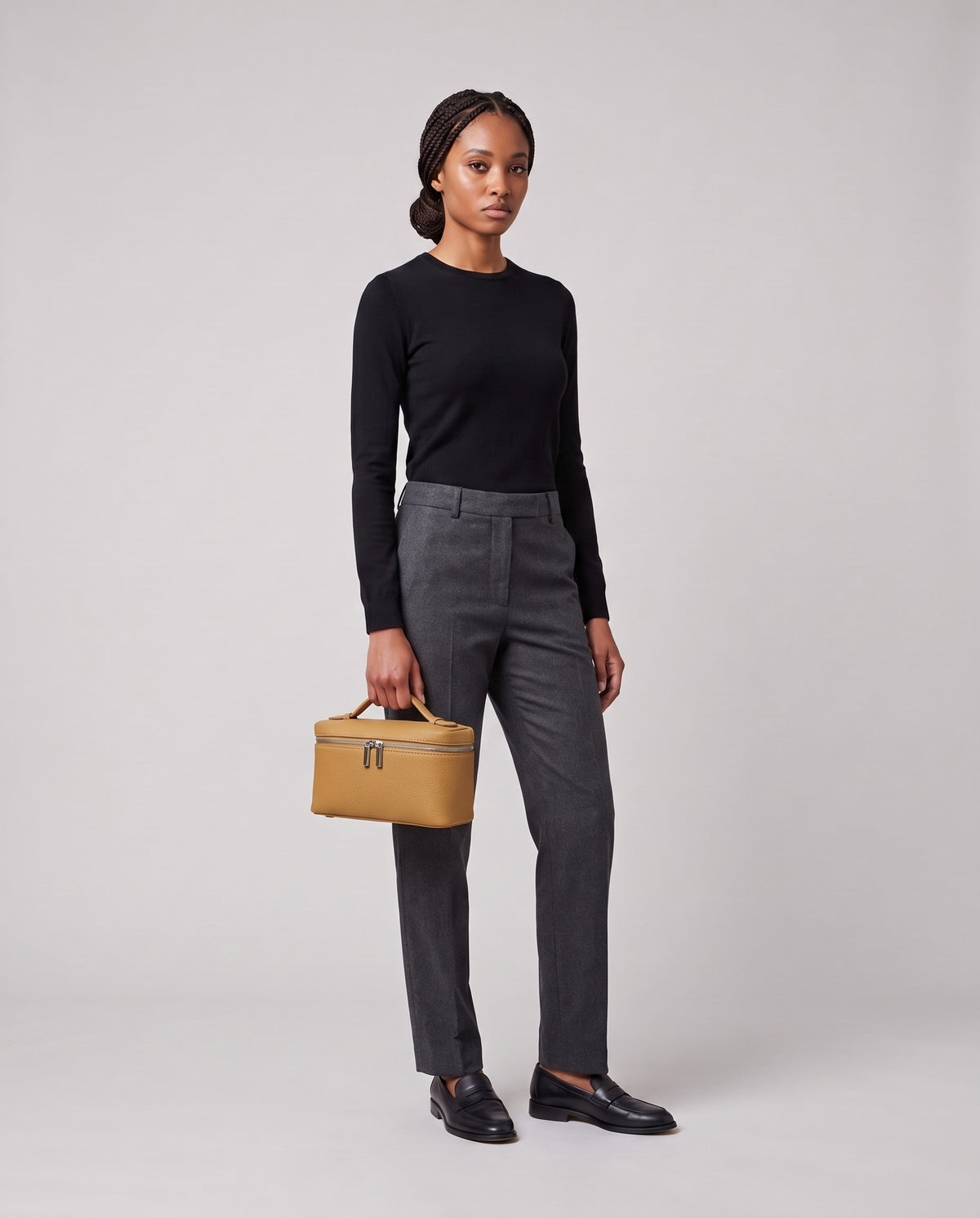 Model holding the Valentina Orvieto Small top-handle bag in Camel leather, full length