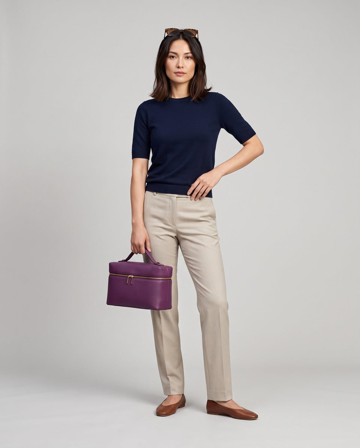 Model holding the Orvieto vanity case in Purple – full-length view