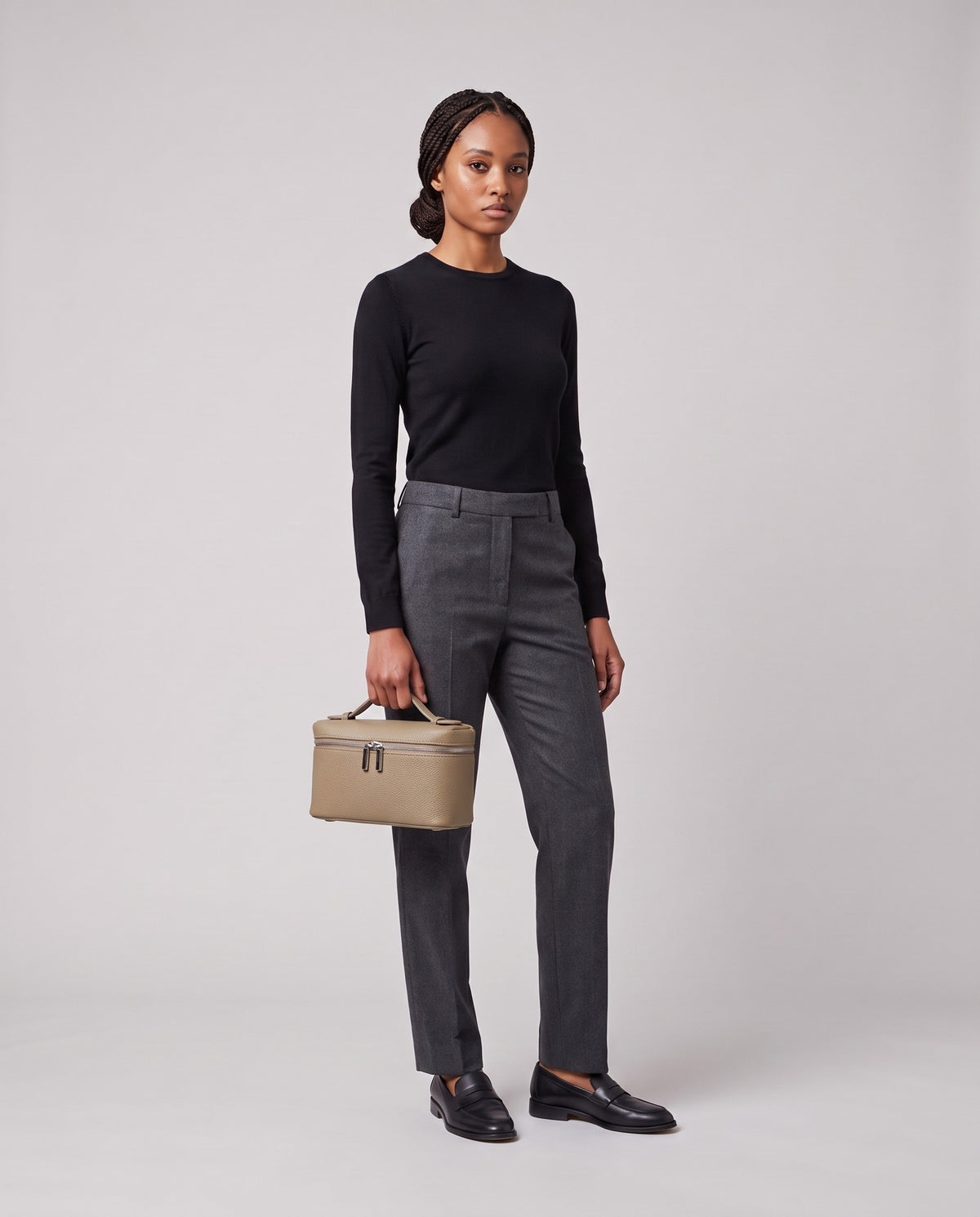 Model holding the Valentina Orvieto Small top-handle bag in Stone leather, full length