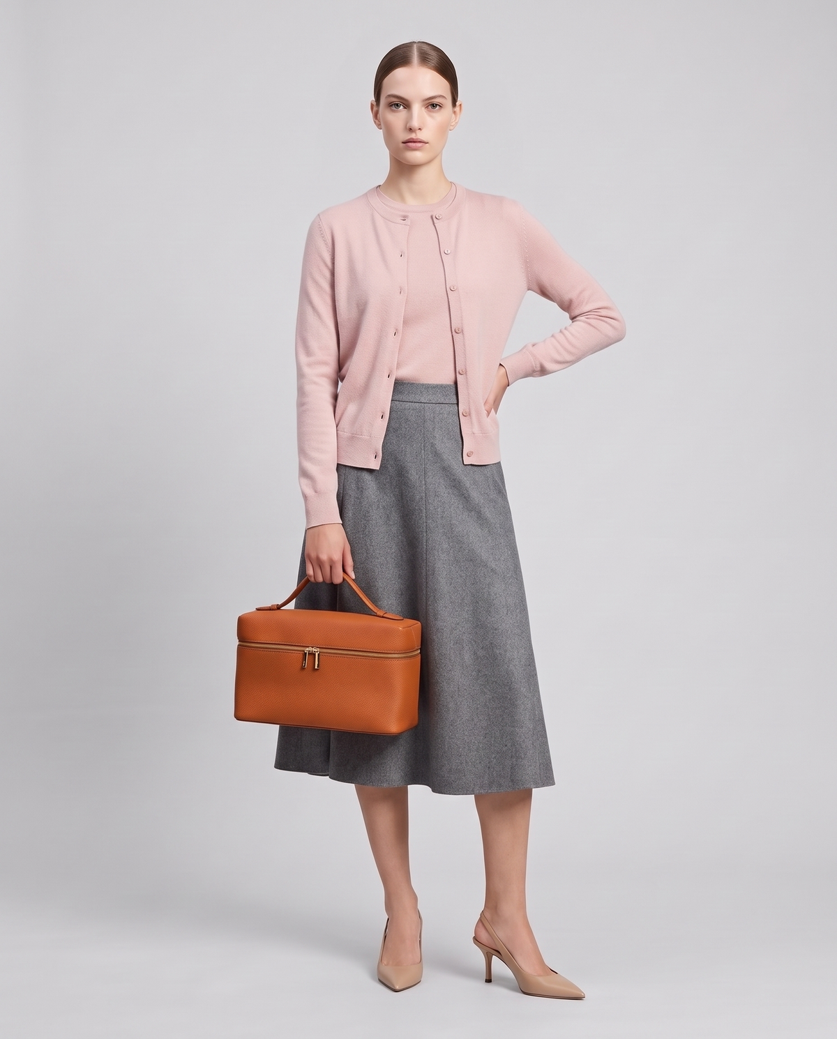 Model holding the Orvieto vanity case in Cognac – full-length view