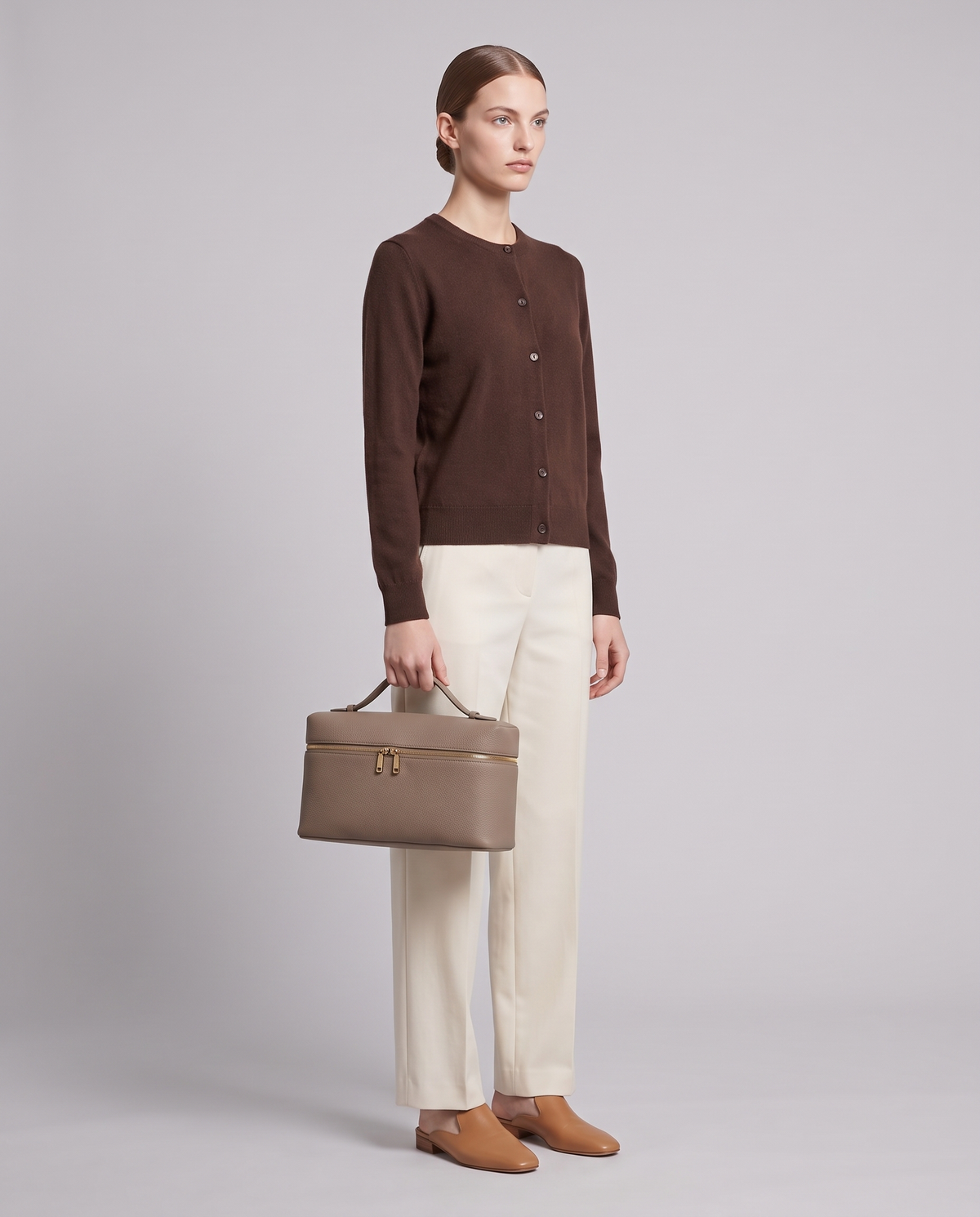 Model holding the Orvieto vanity case in Ivory – full-length view