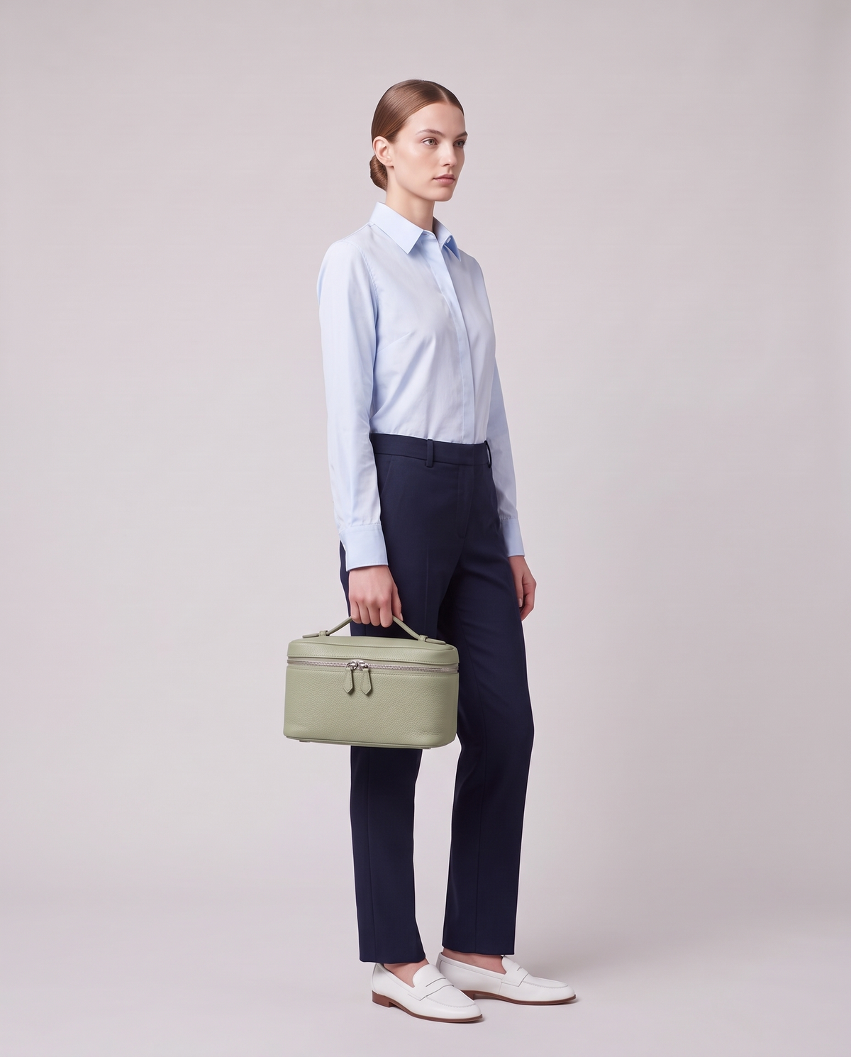 Model holding the Orvieto vanity case in Orange – full-length view