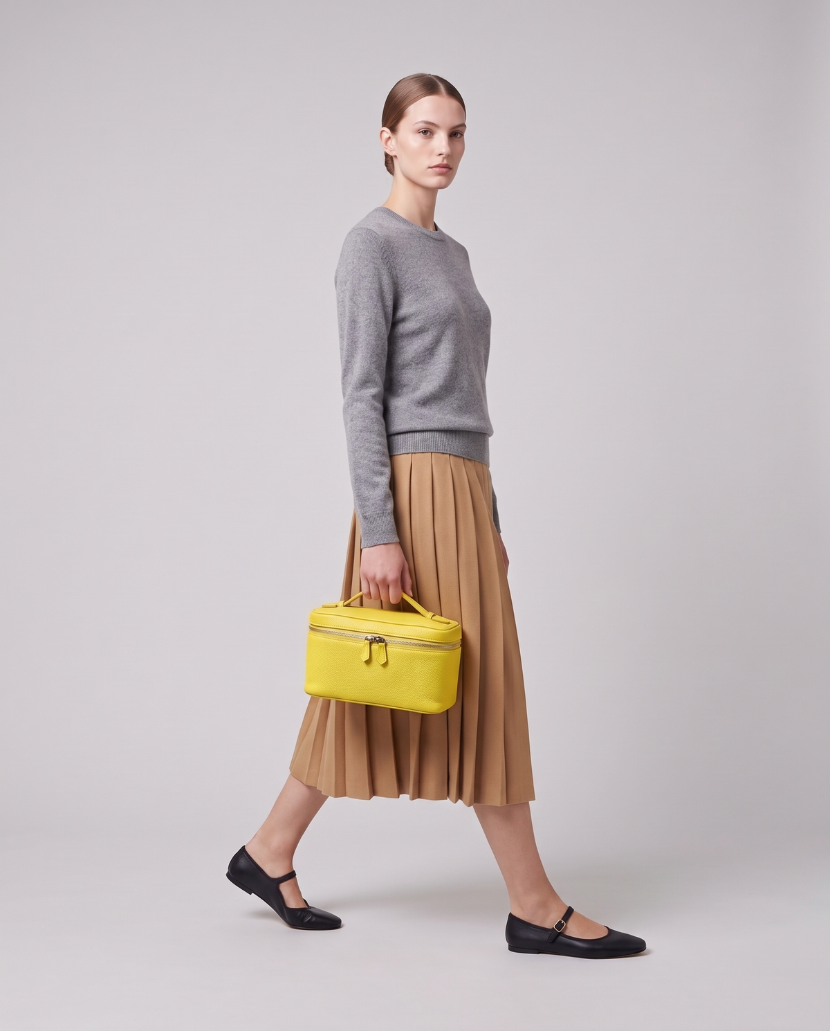 Model holding the Orvieto vanity case in Yellow – full-length view