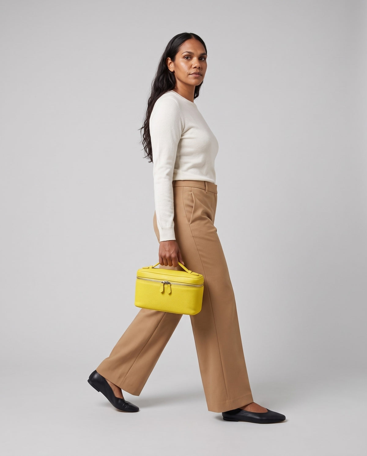 Model holding the Orvieto vanity case in Yellow – full-length view
