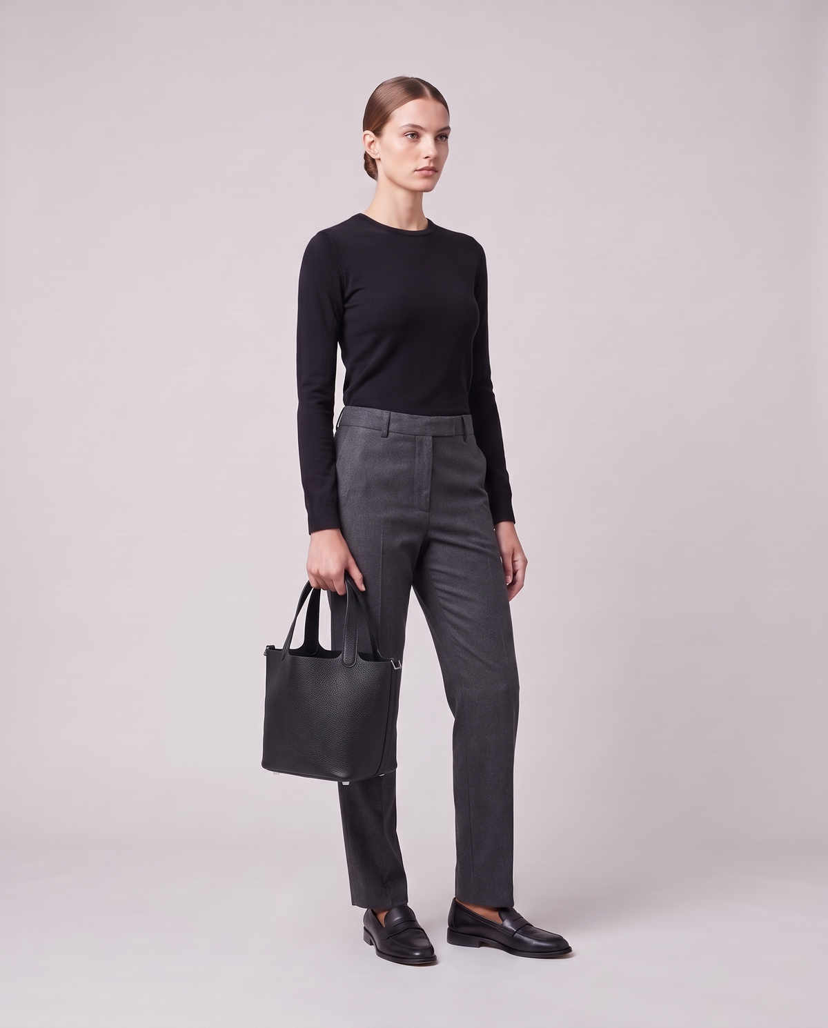 Model holding the Valentina Ostuni Large bag in Black, full length