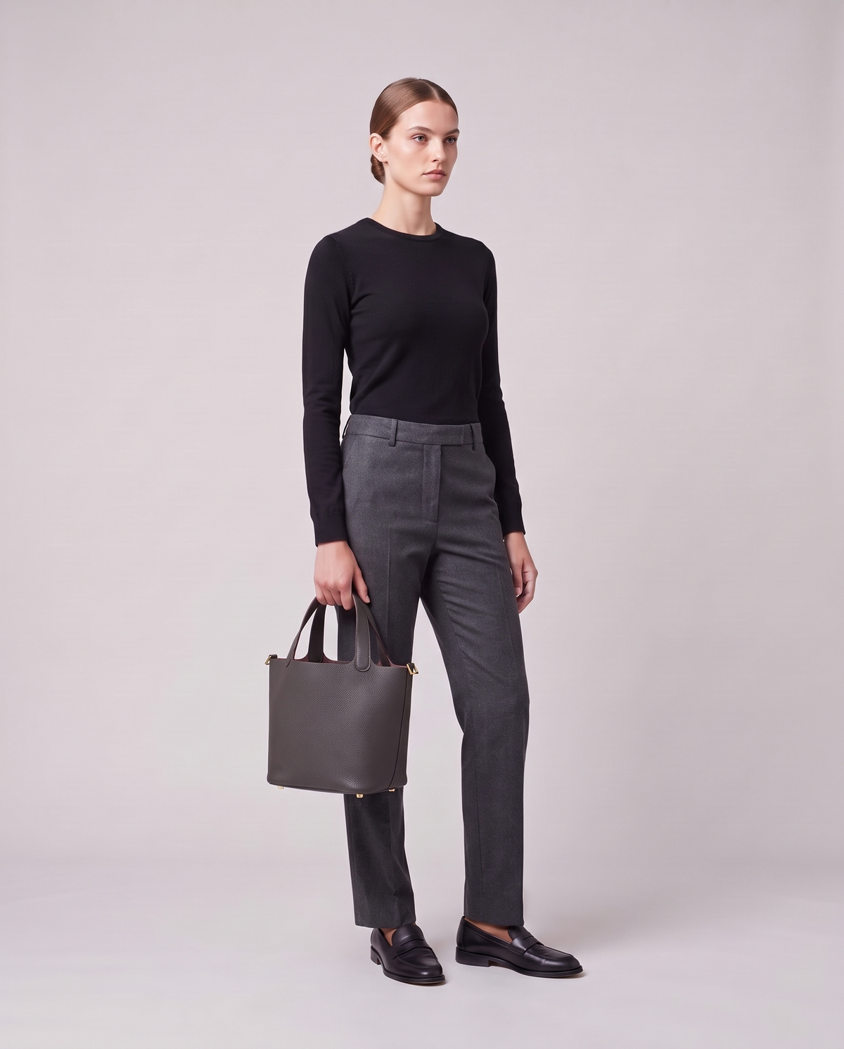 Model holding the Valentina Ostuni Large bag in Charcoal, full length