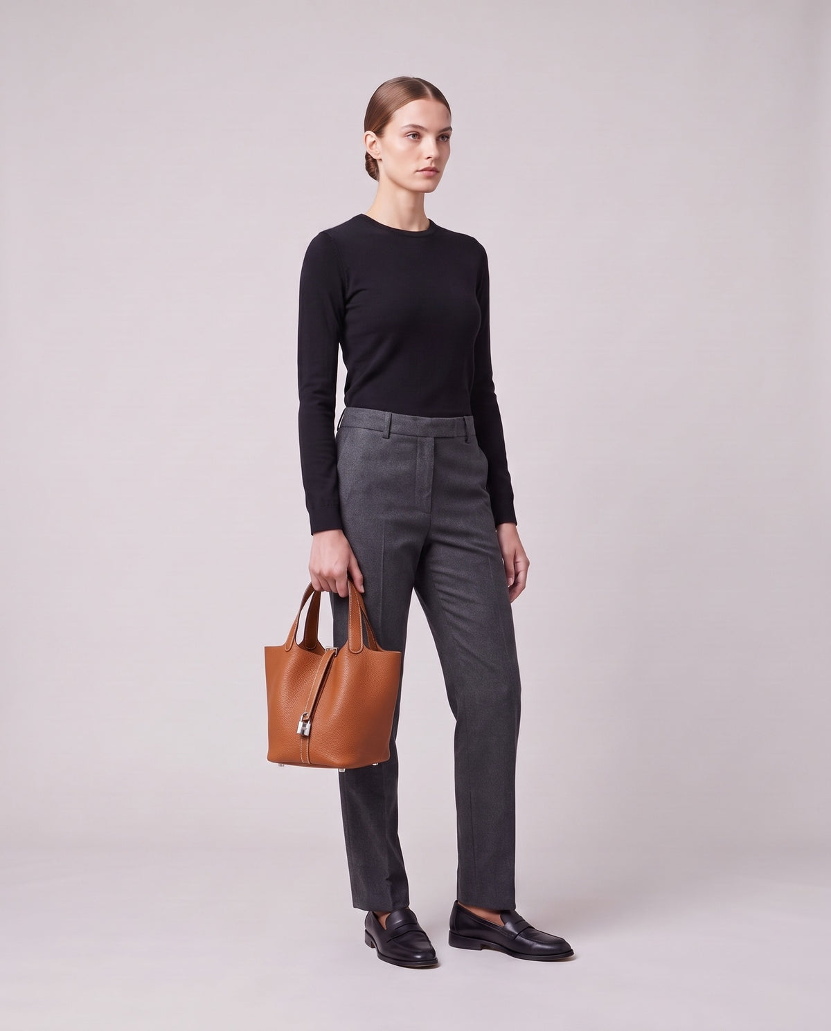 Model holding the Valentina Ostuni Large bag in Cognac, full length