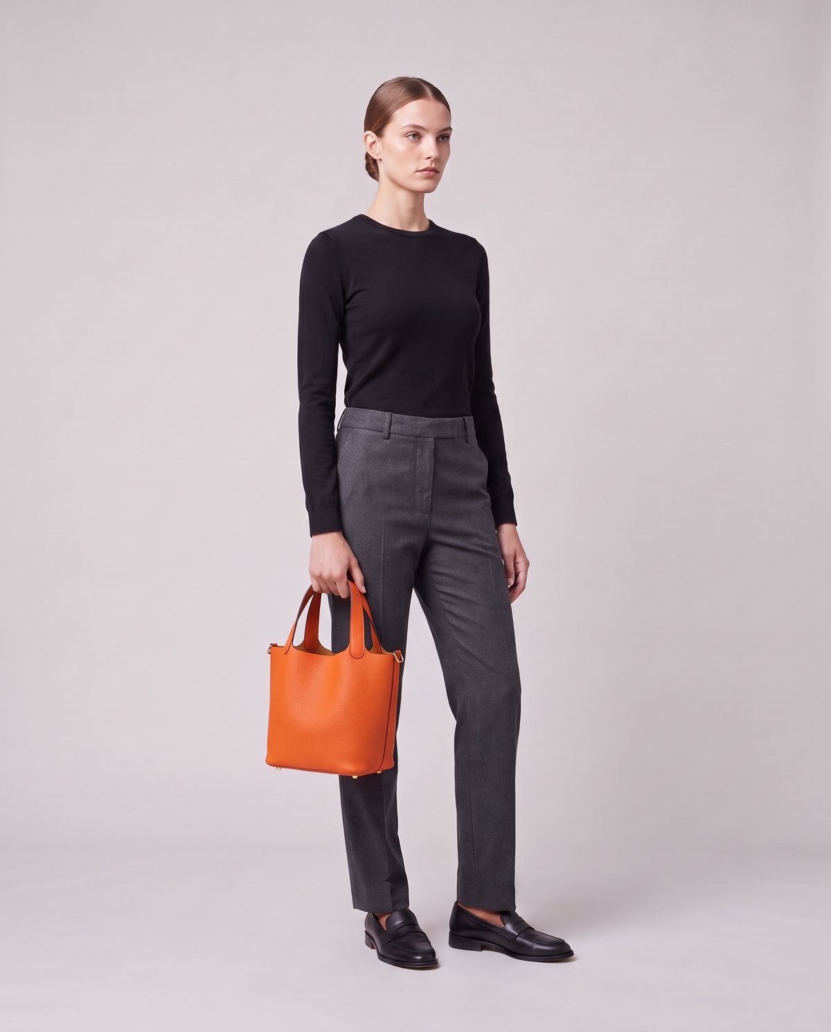 Model holding the Valentina Ostuni Large bag in Orange, full length