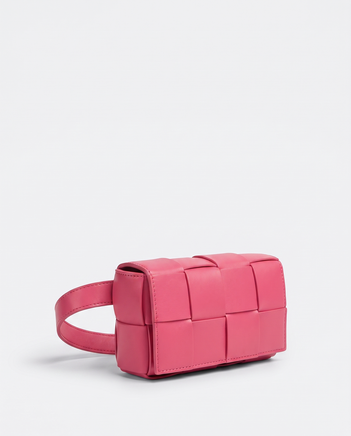 Cassette padded woven leather belt bag in Pink – three-quarter view